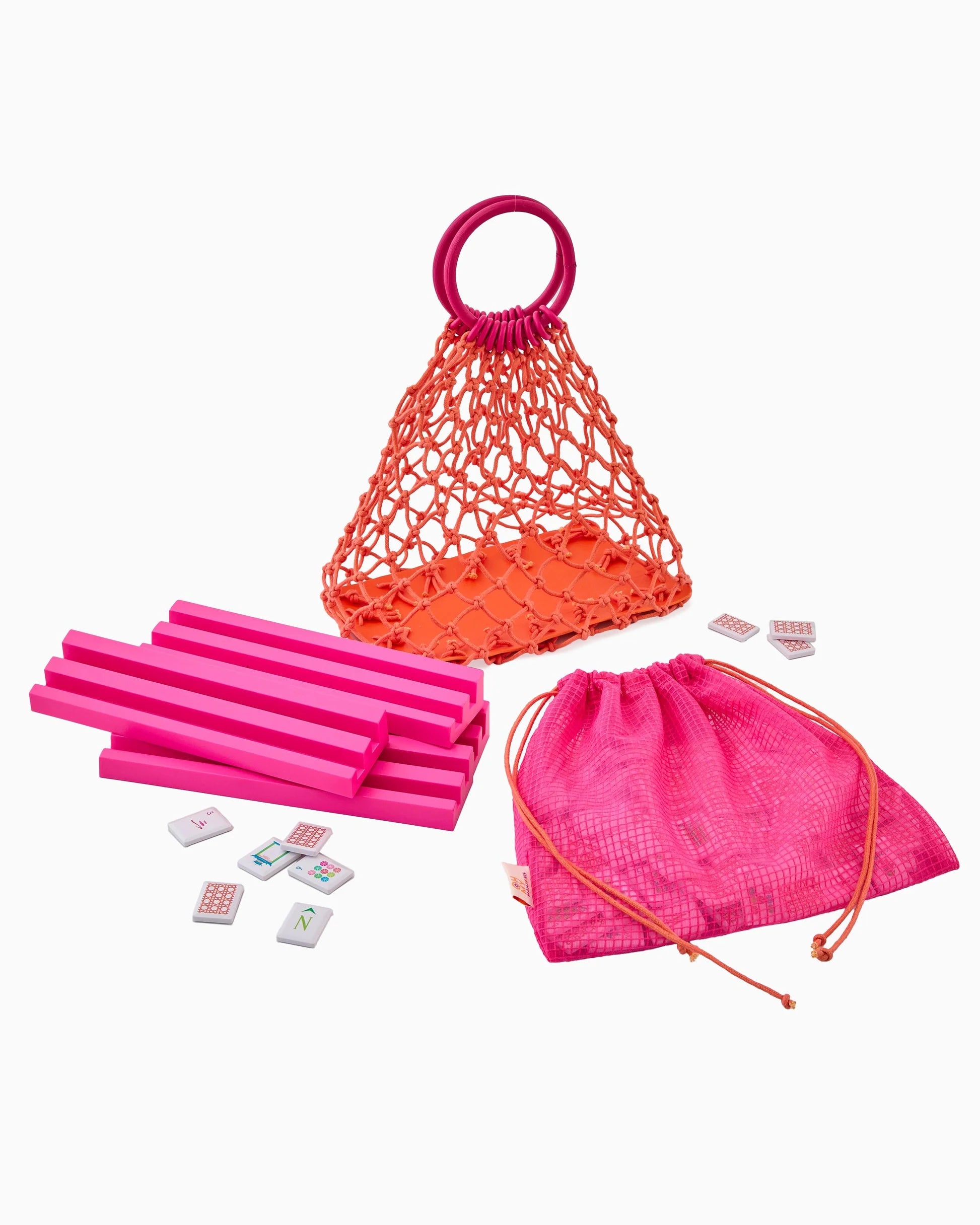 Set of pink and orange items including a net bag, drawstring bag, and small rectangular objects on a white background.