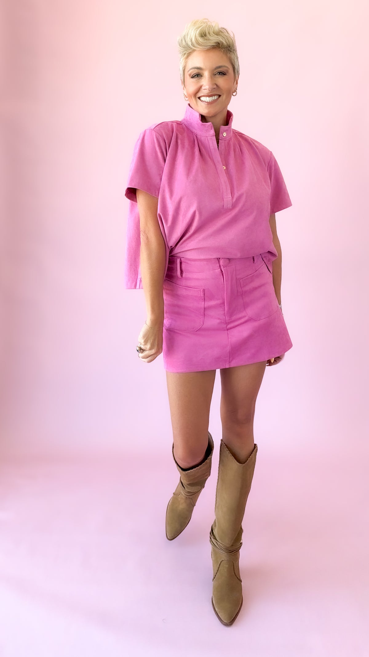 Front view of pink faux suede skort with matching short sleeve top
