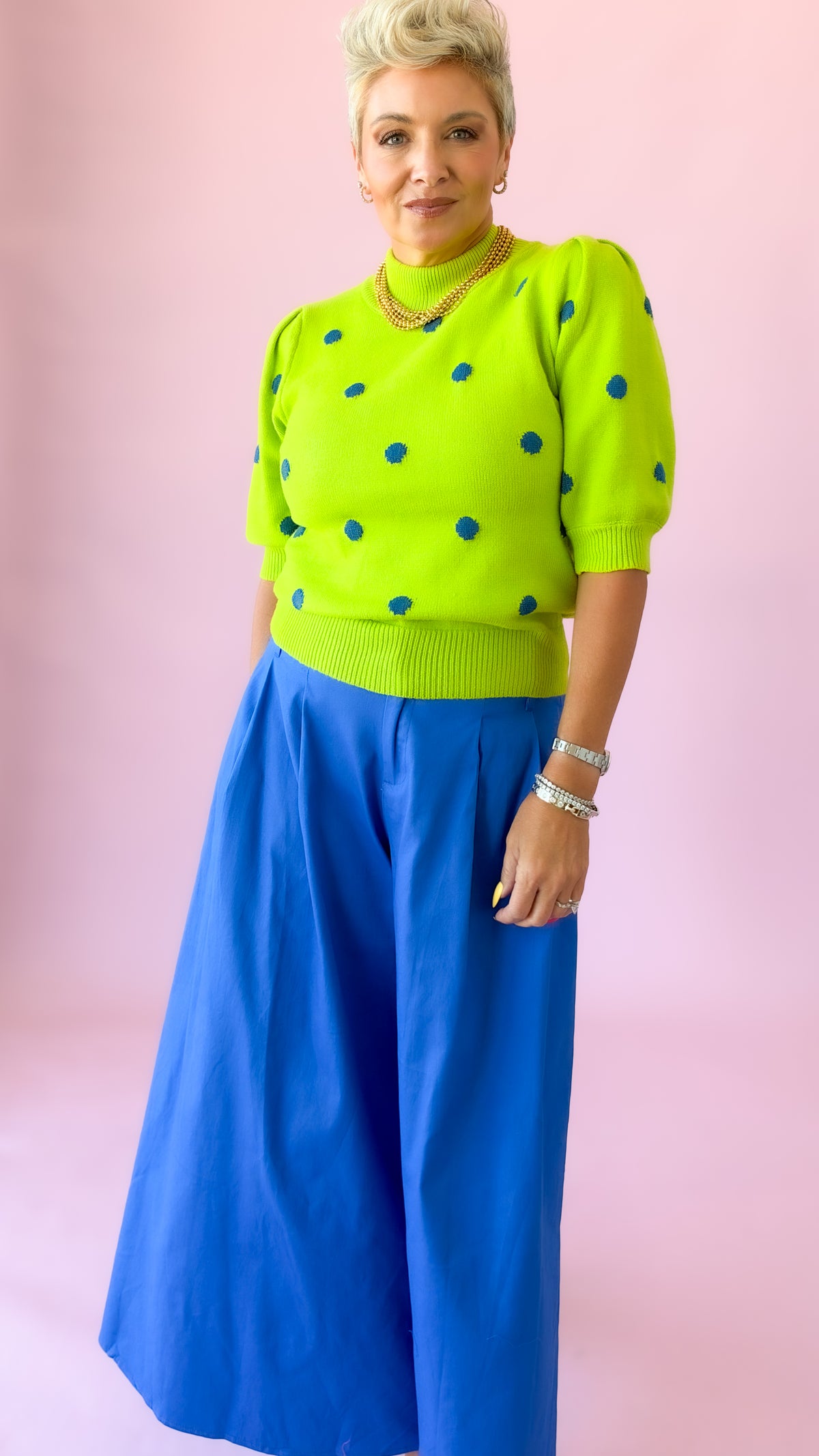 Side view of lime dot mock neck sweater with cobalt culottes
