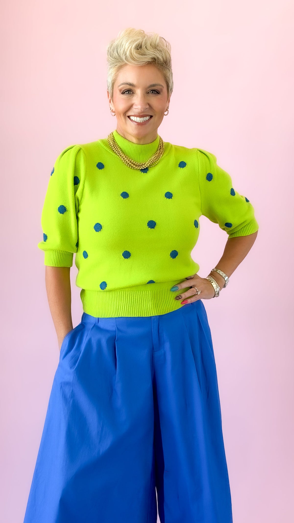 Lime green mock neck sweater with blue polka dots and short puff sleeves
