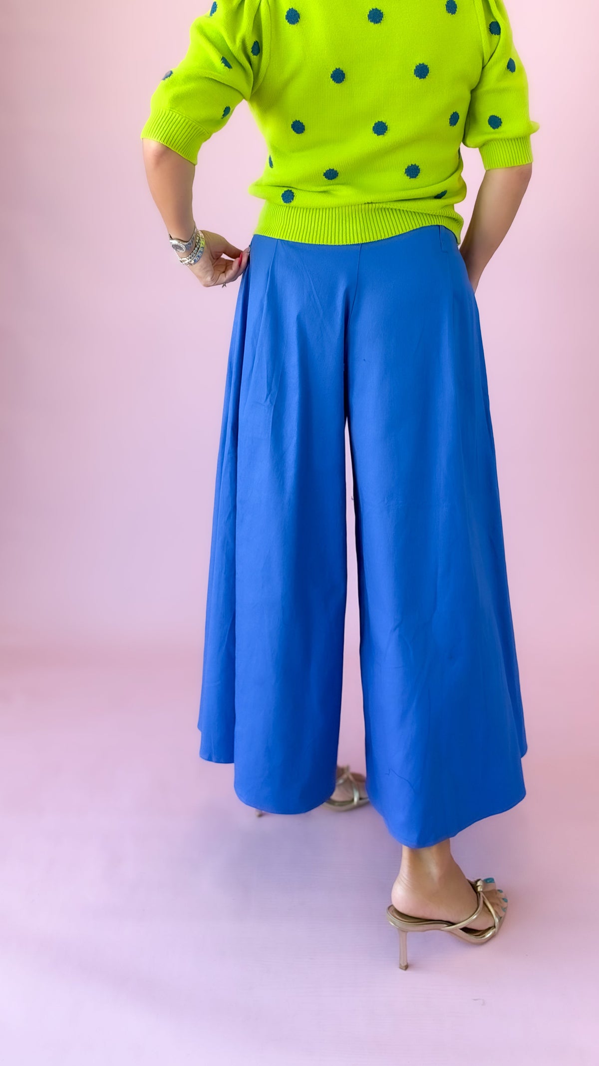Side view of cobalt blue pleated wide-leg culottes