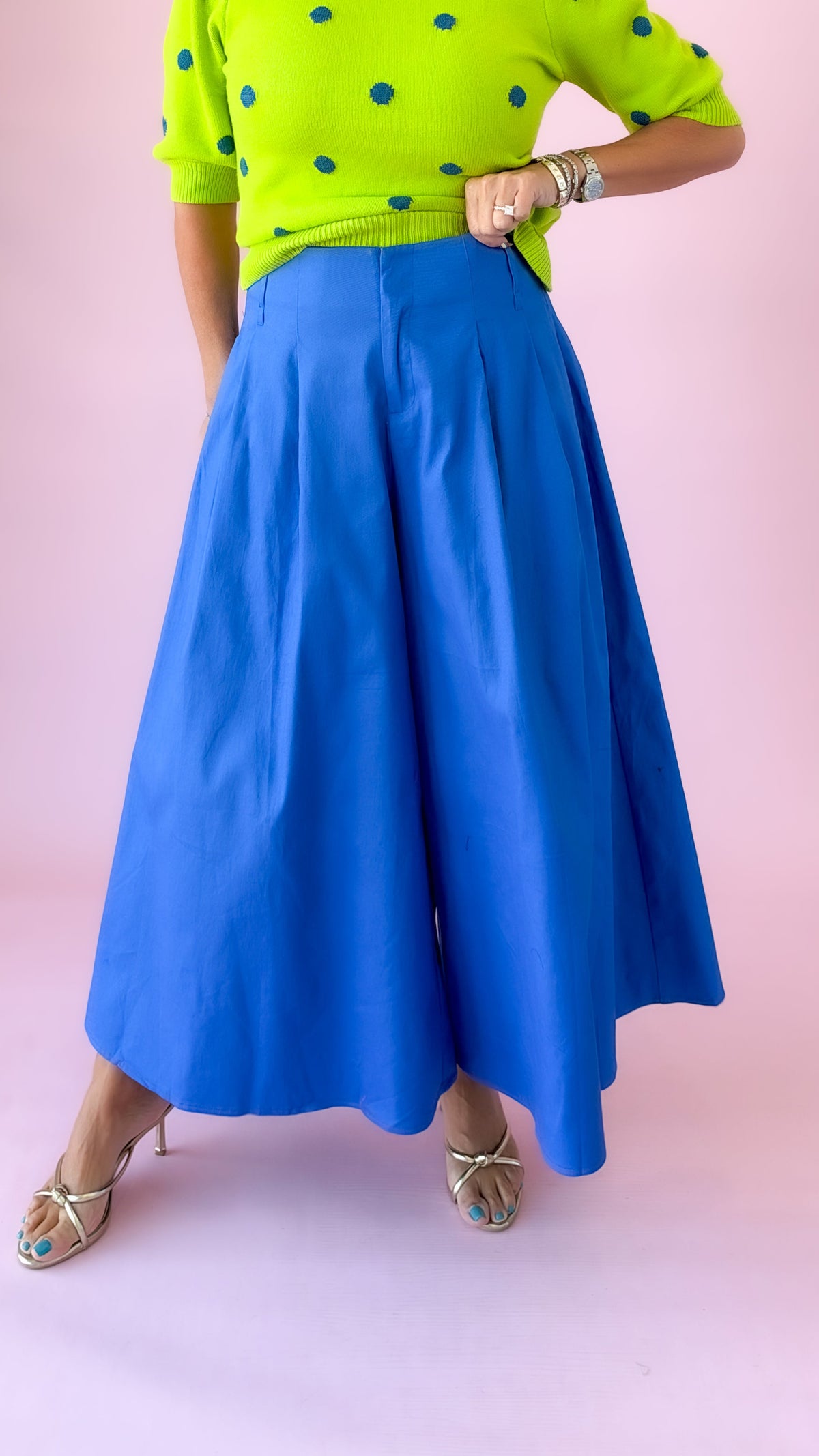Cobalt blue pleated wide-leg culotte pants styled with a lime dot sweater