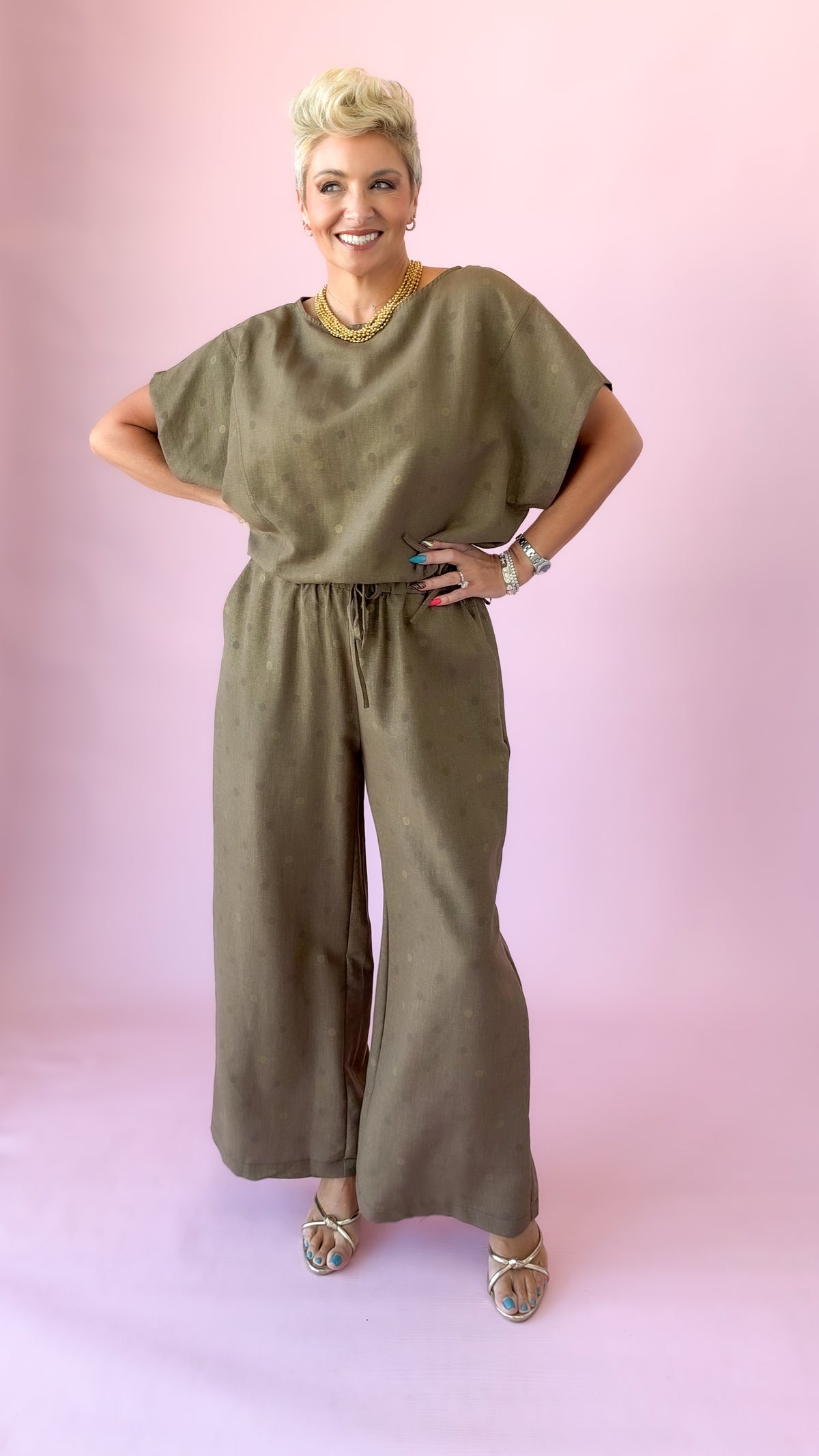 Full-length view of brown round neck polka dot top and matching pants