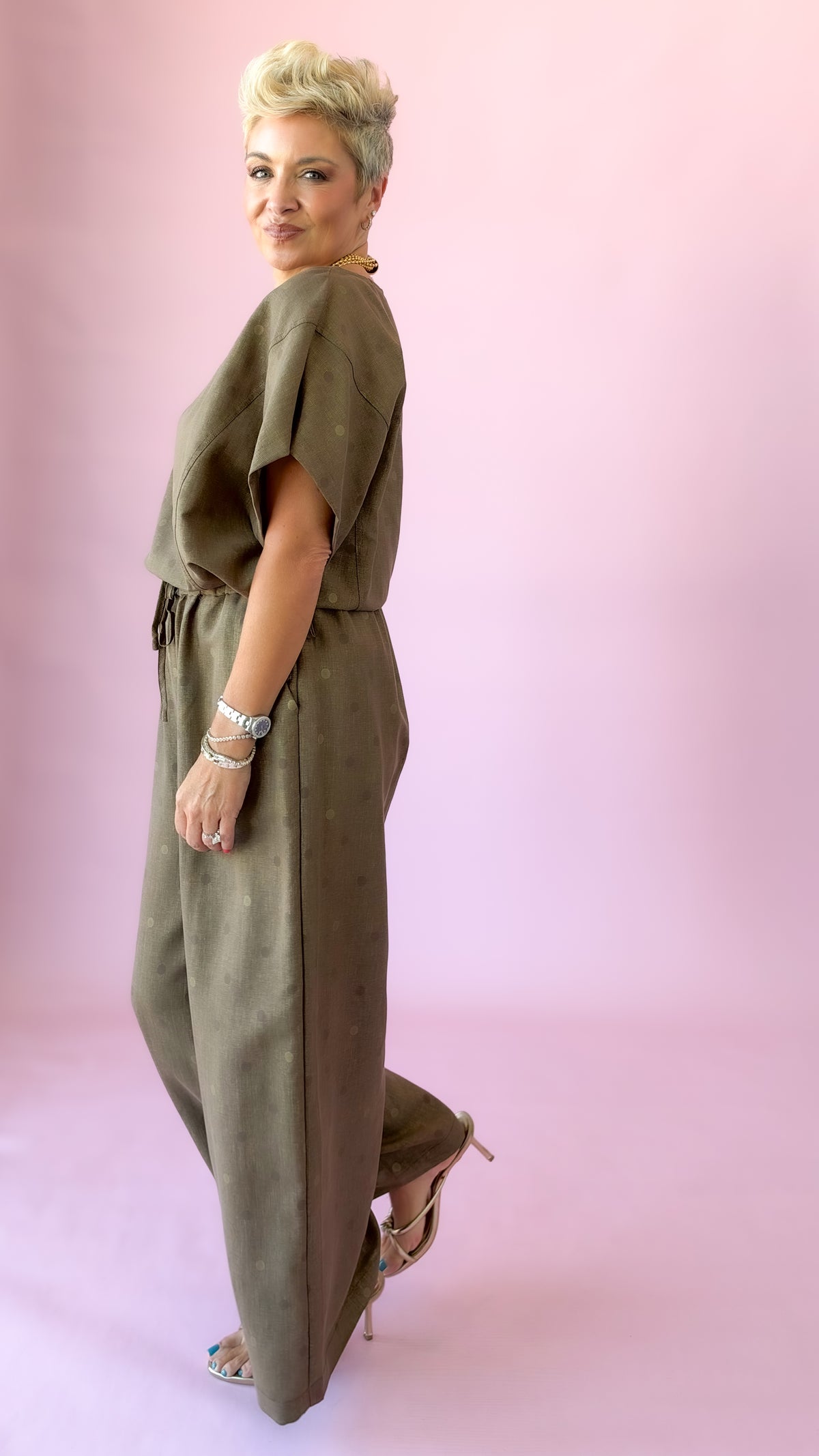 Side view of brown wide-leg polka dot pants with matching top