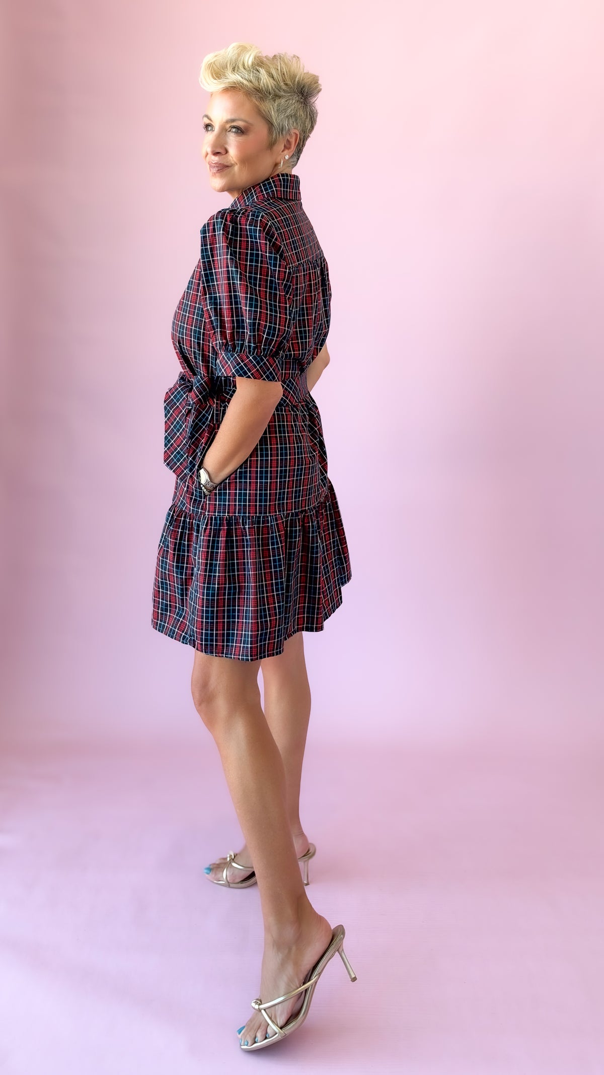 Side profile of the navy plaid Angelica mini dress with tiered ruffle hem