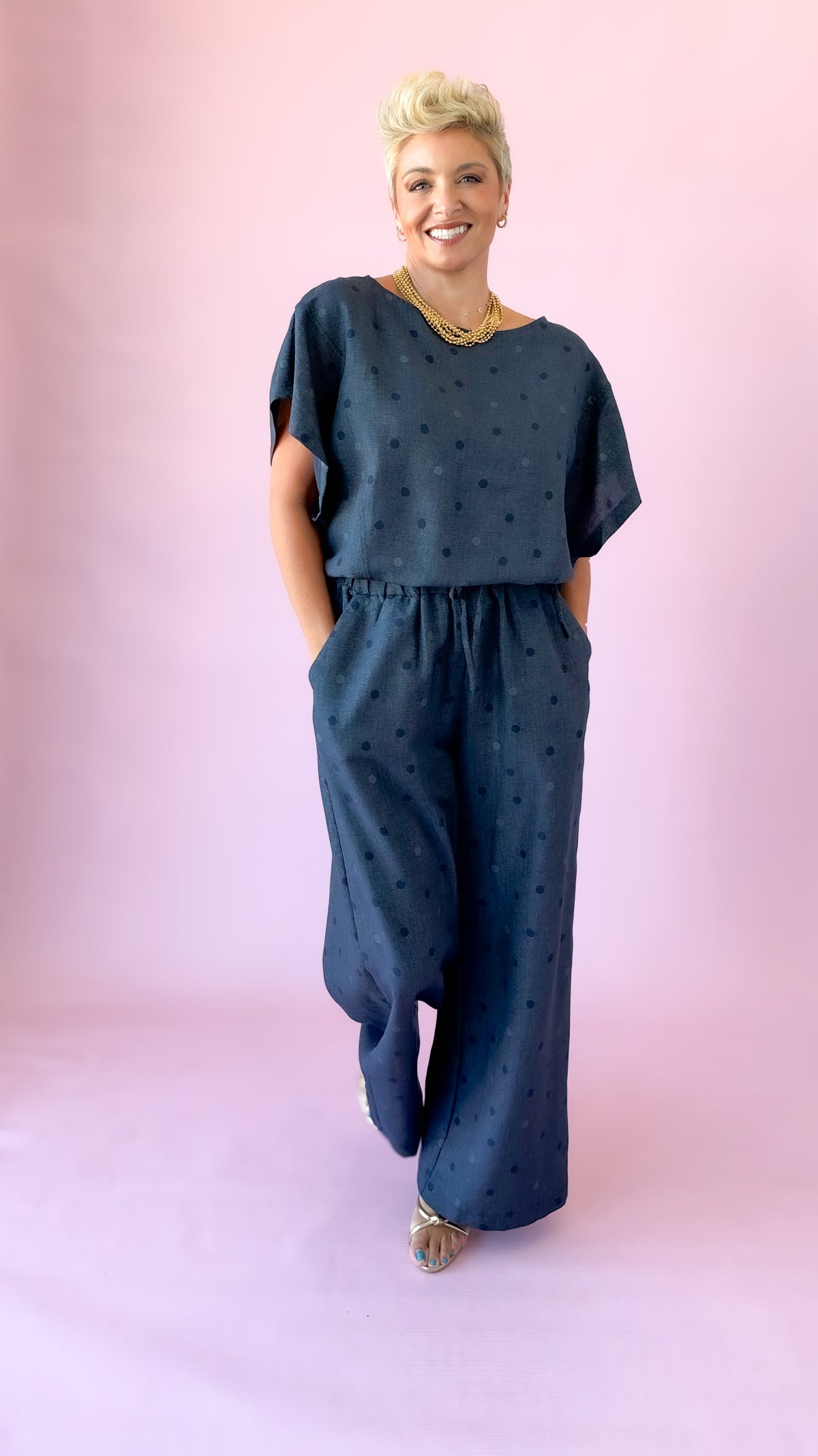 Full-length view of indigo round neck polka dot top set