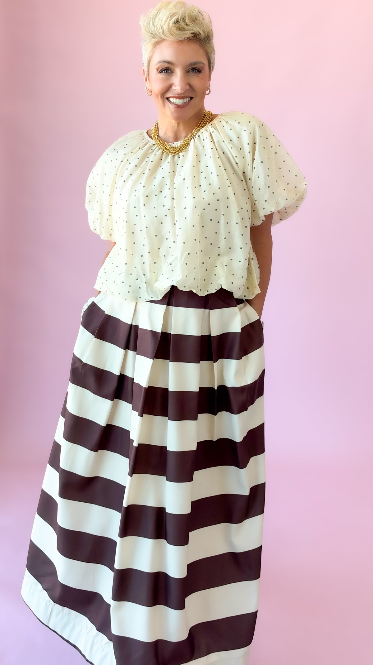Ivory flutter puff sleeve blouse styled with a brown and white striped skirt