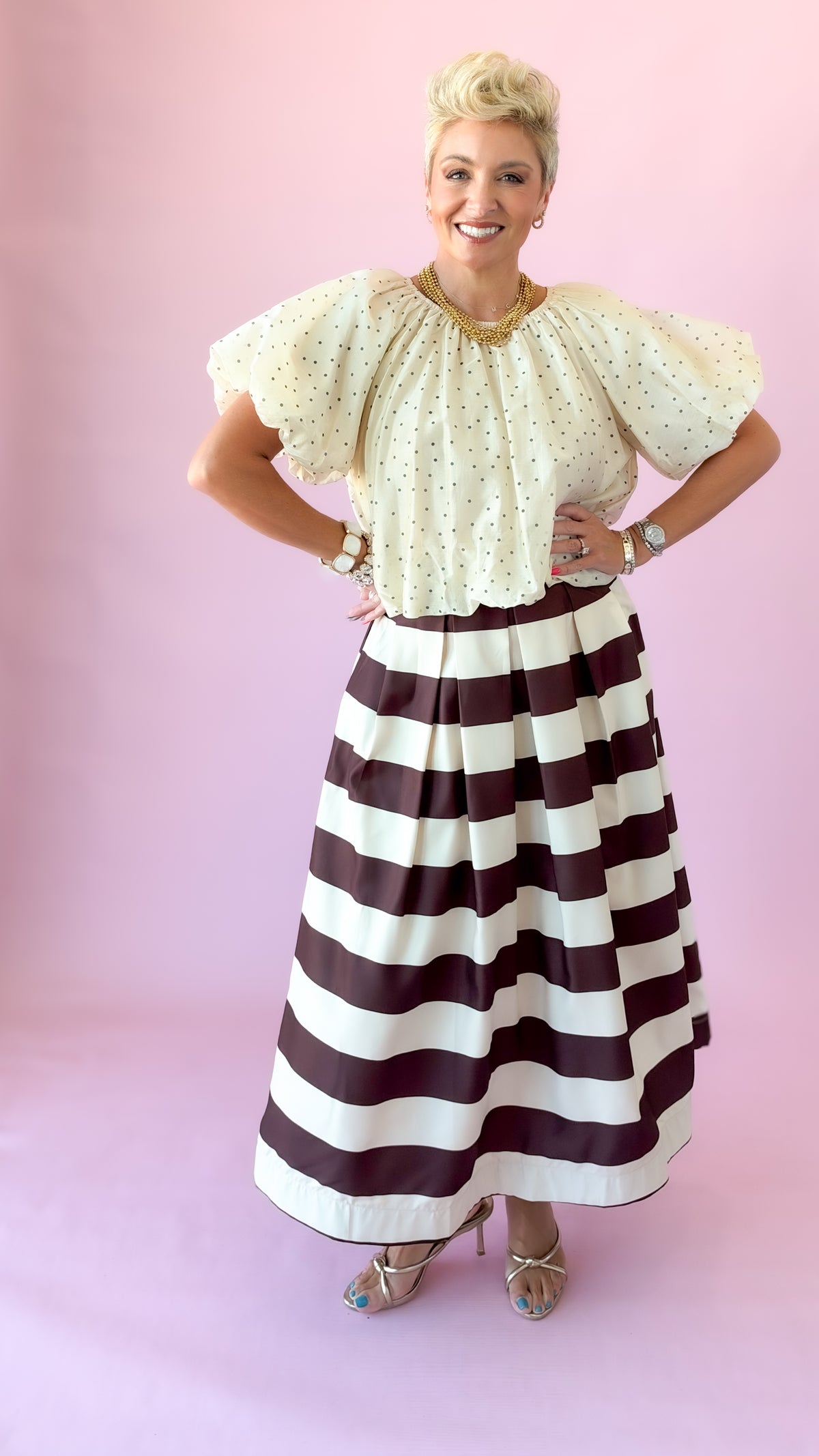 Full-length view of ivory flutter puff sleeve top with hands on hips
