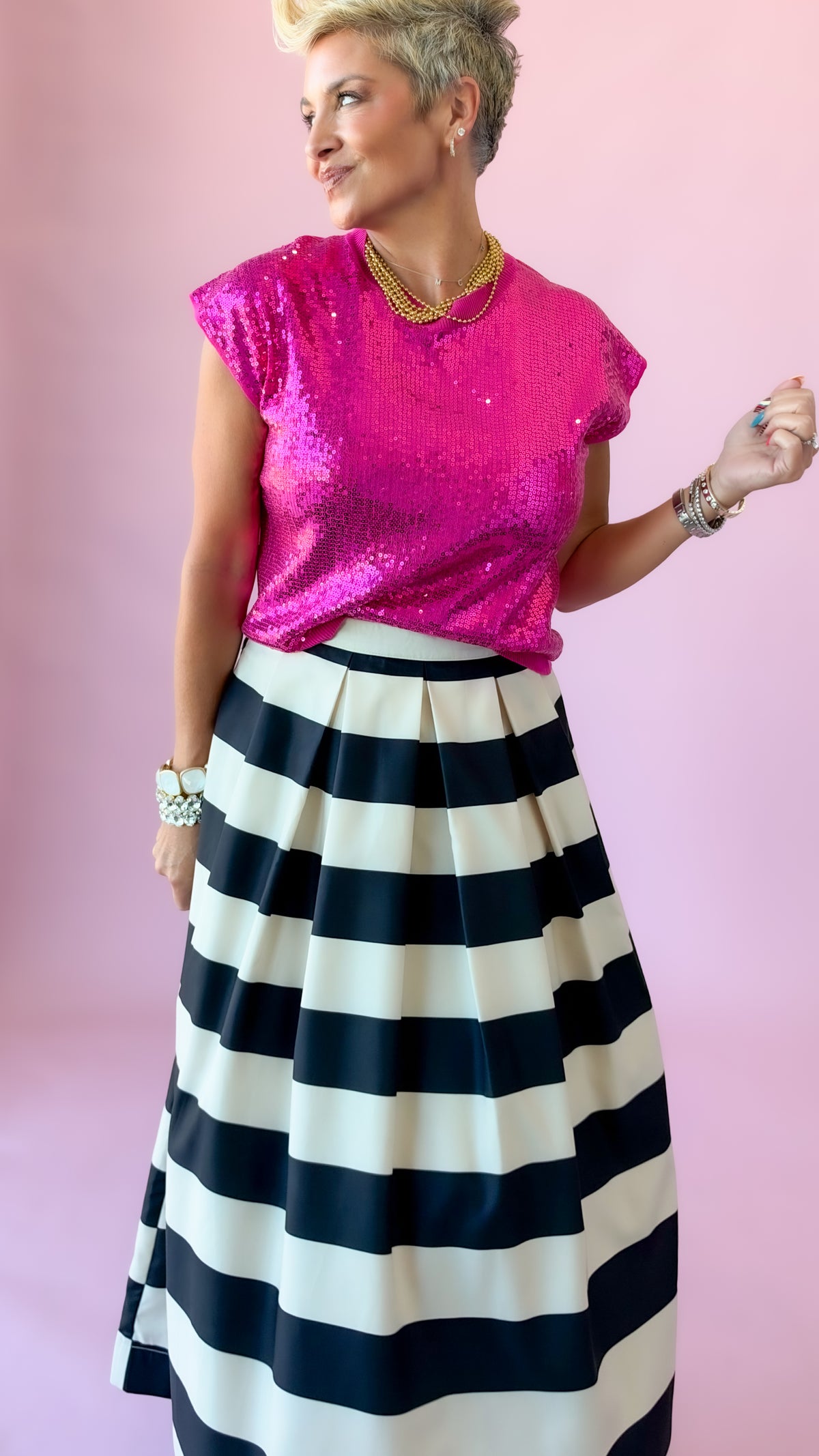 Hot pink Sierra sequin top styled with a black and white striped midi skirt