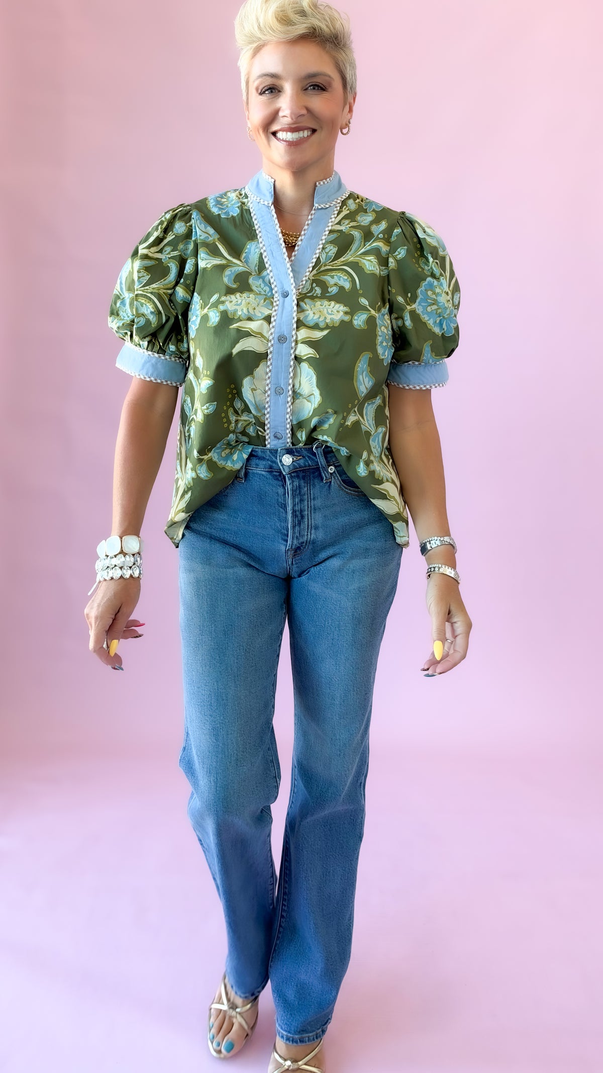 Full-length view of green floral Jennifer puff sleeve top with straight-leg jeans