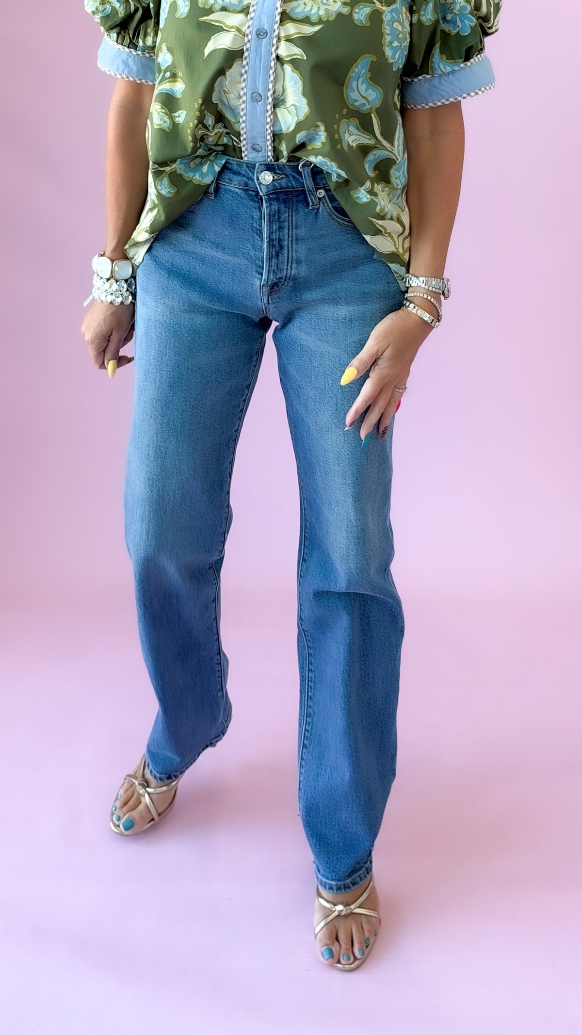 Medium wash Westgate vintage straight leg jeans styled with a green floral top