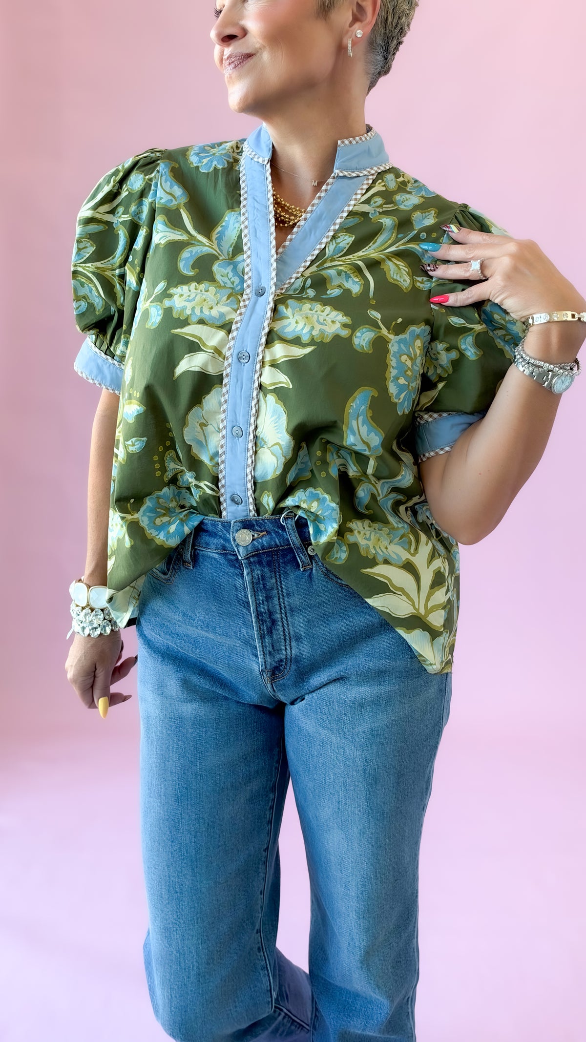 Angled close-up of green floral Jennifer top showing puff sleeves and chambray trim