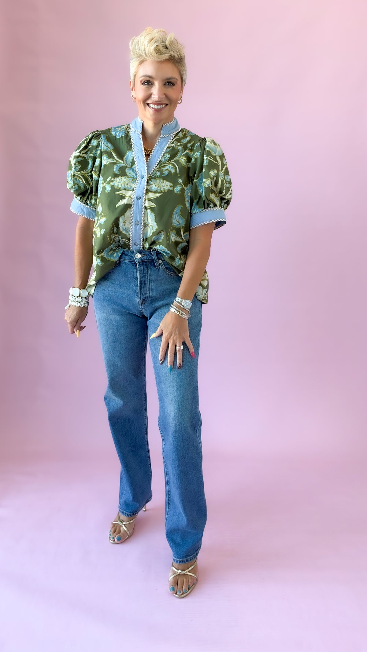 Full-length front view of Westgate vintage straight jeans with a green floral puff sleeve top