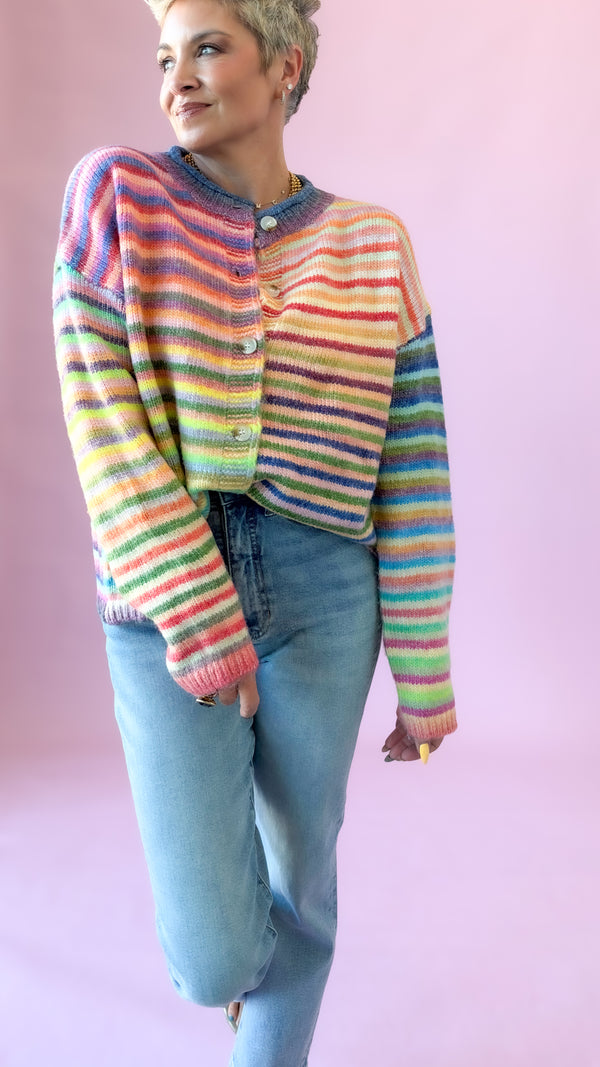 Pastel rainbow striped button-up cardigan styled with light wash jeans