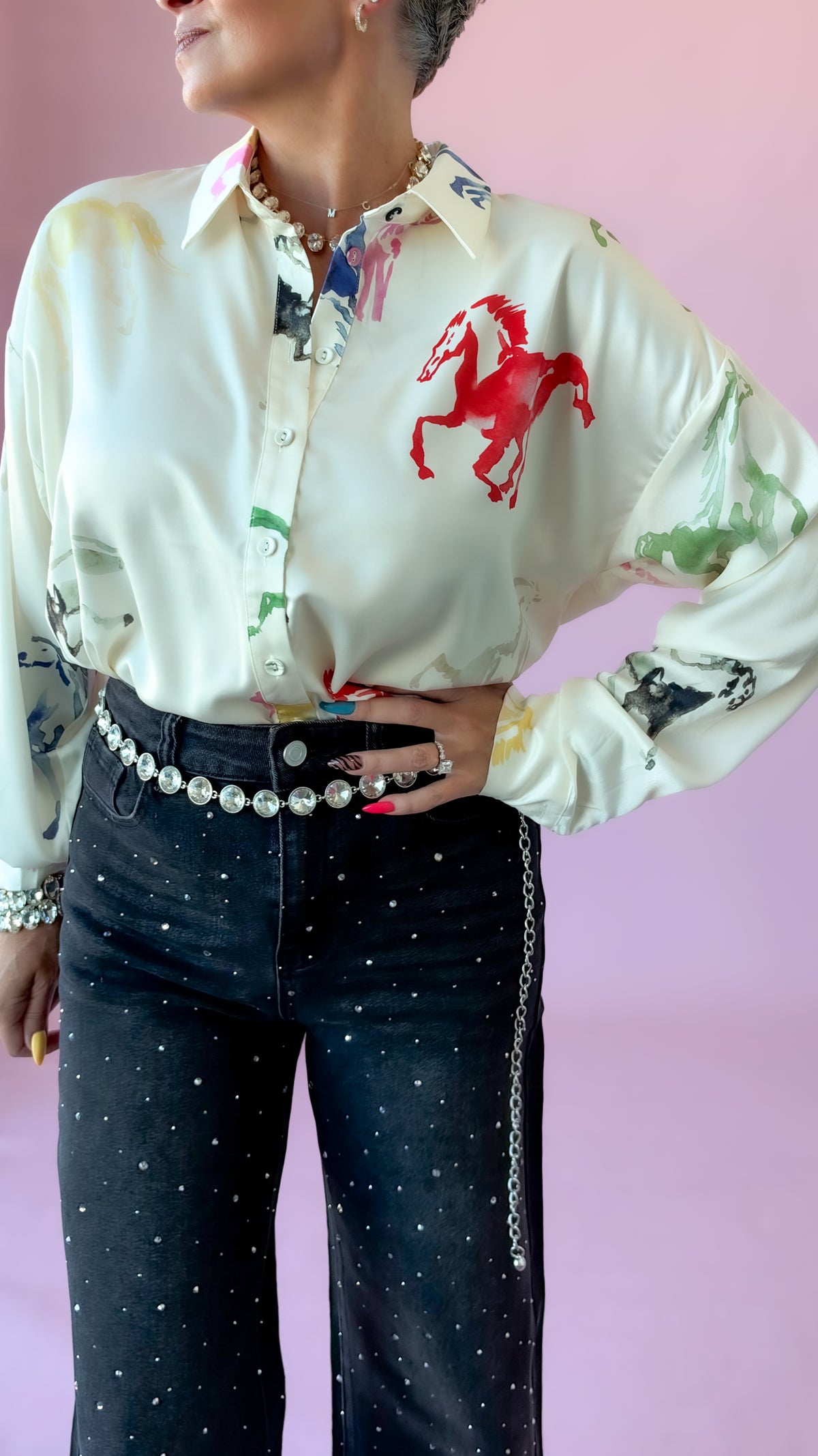 Cream watercolor horse blouse with pearl belt and black studded jeans