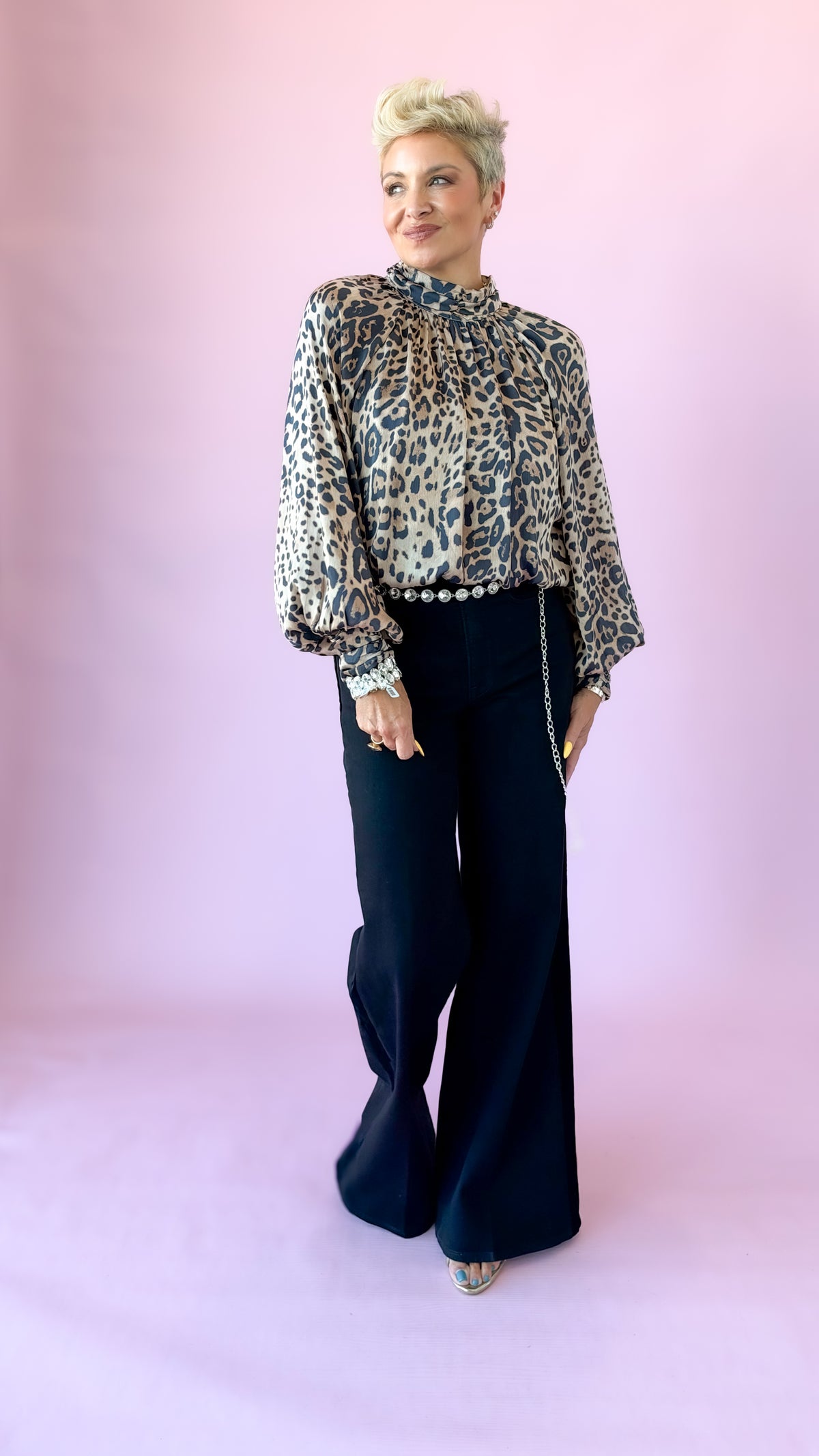 Full-length front view of Jessie leopard top and black wide-leg pants