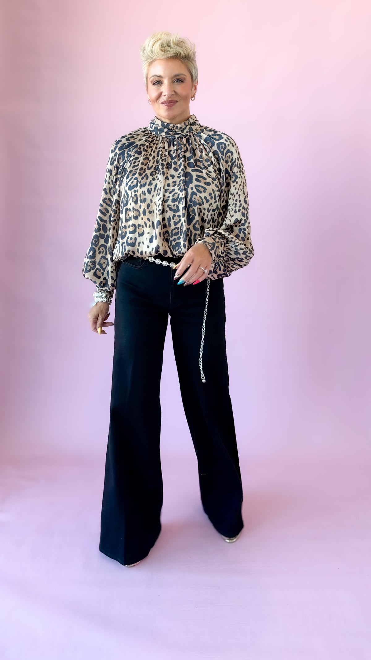 Full-length view of black velvet side stripe palazzo jeans with leopard top