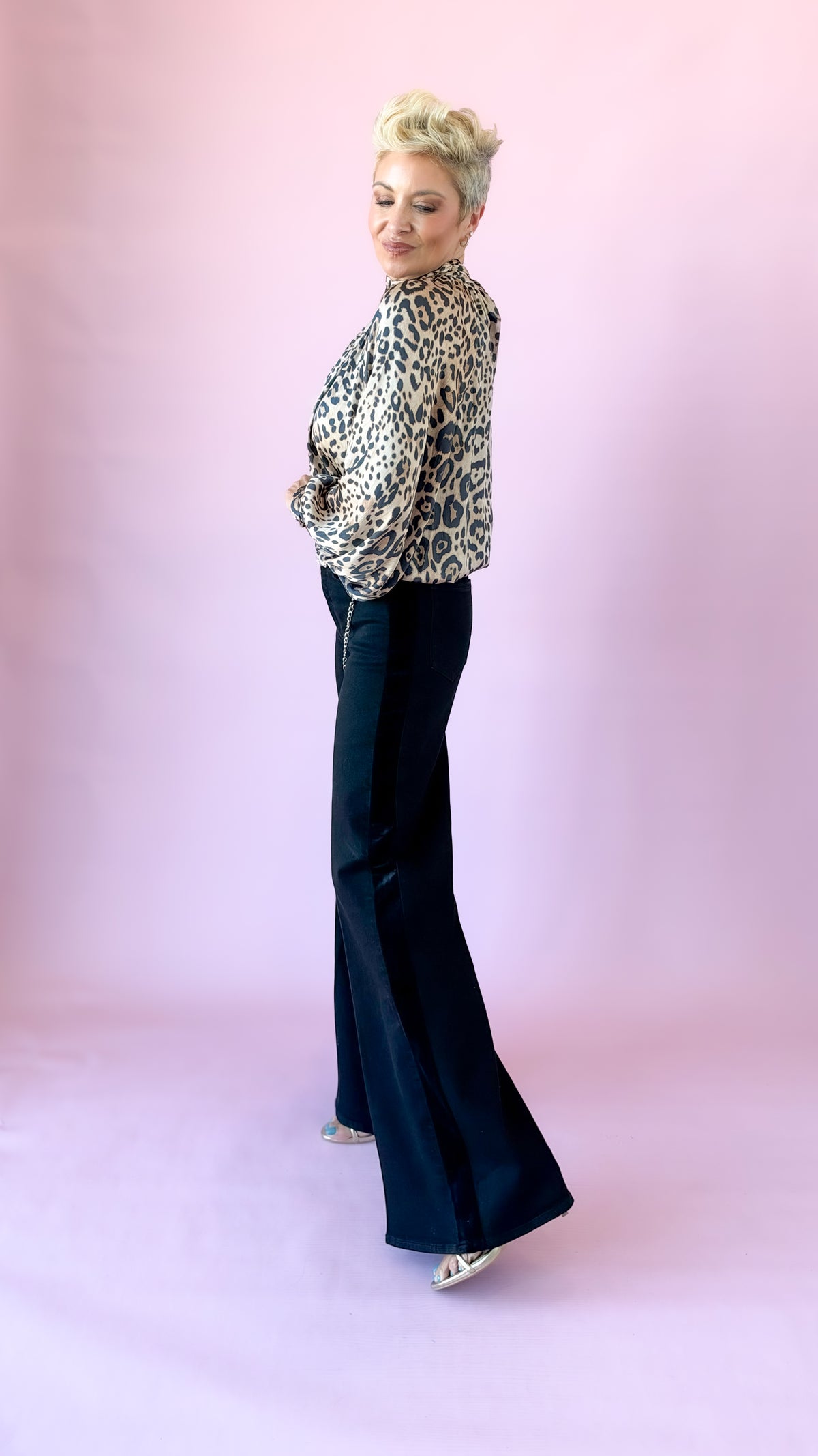 Side view of black palazzo jeans showing the velvet side stripe
