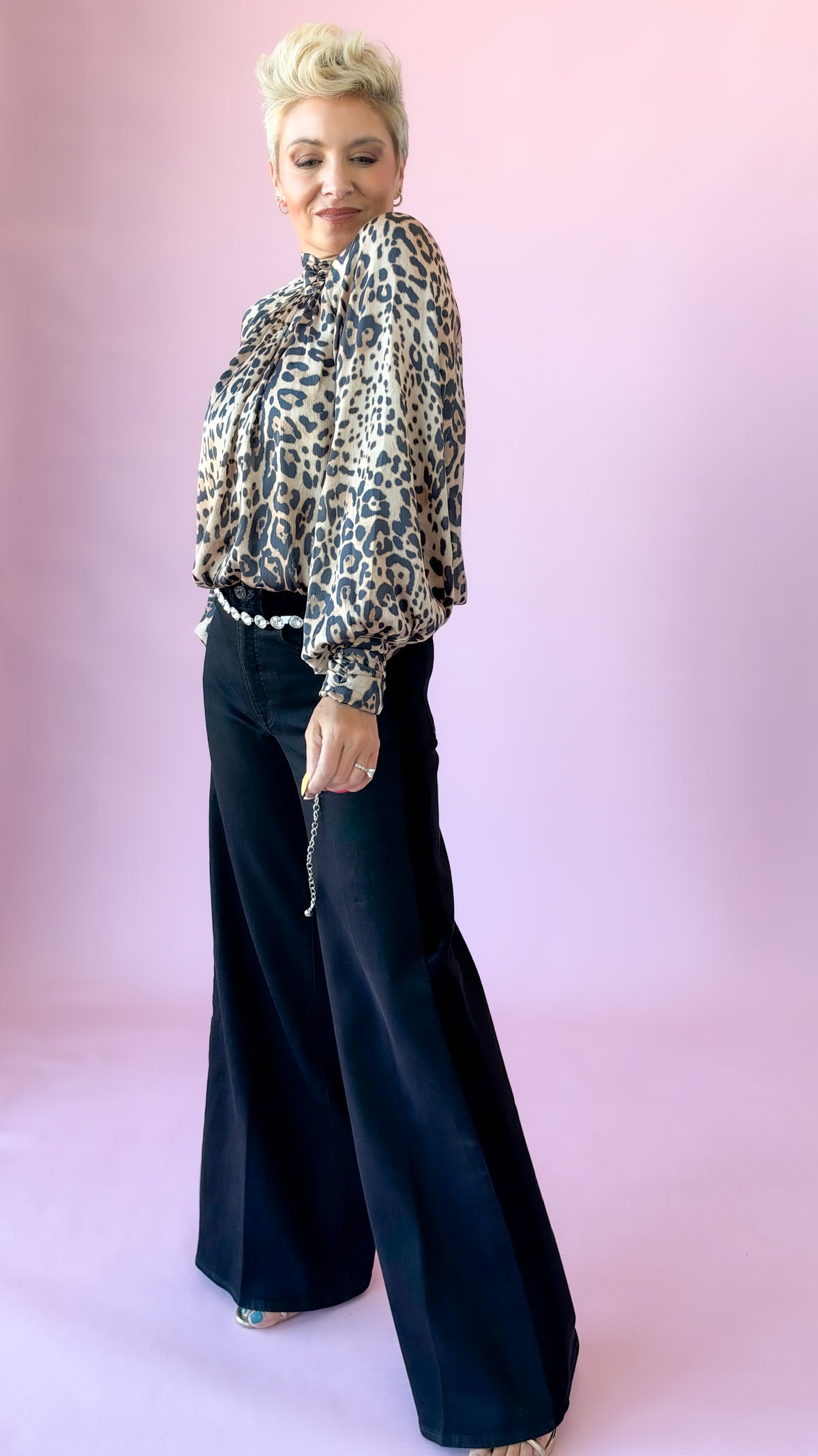 Black side stripe palazzo jeans with leopard print blouse, side angle