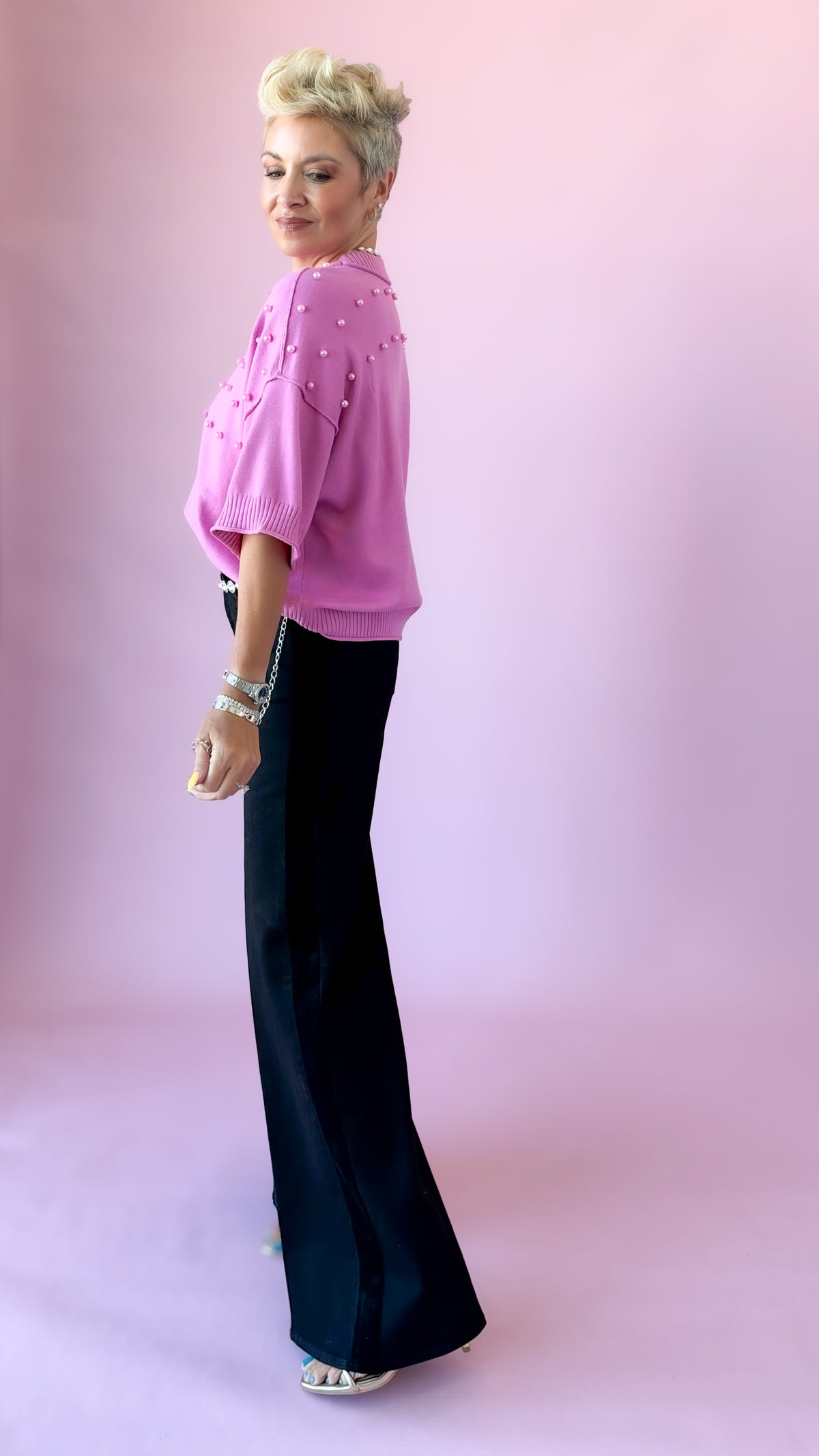 Side view of pink pearl crewneck sweater