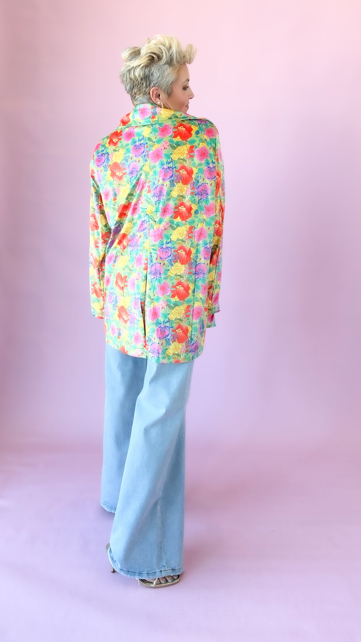 Back view of oversized multicolor floral velvet blazer with wide-leg jeans