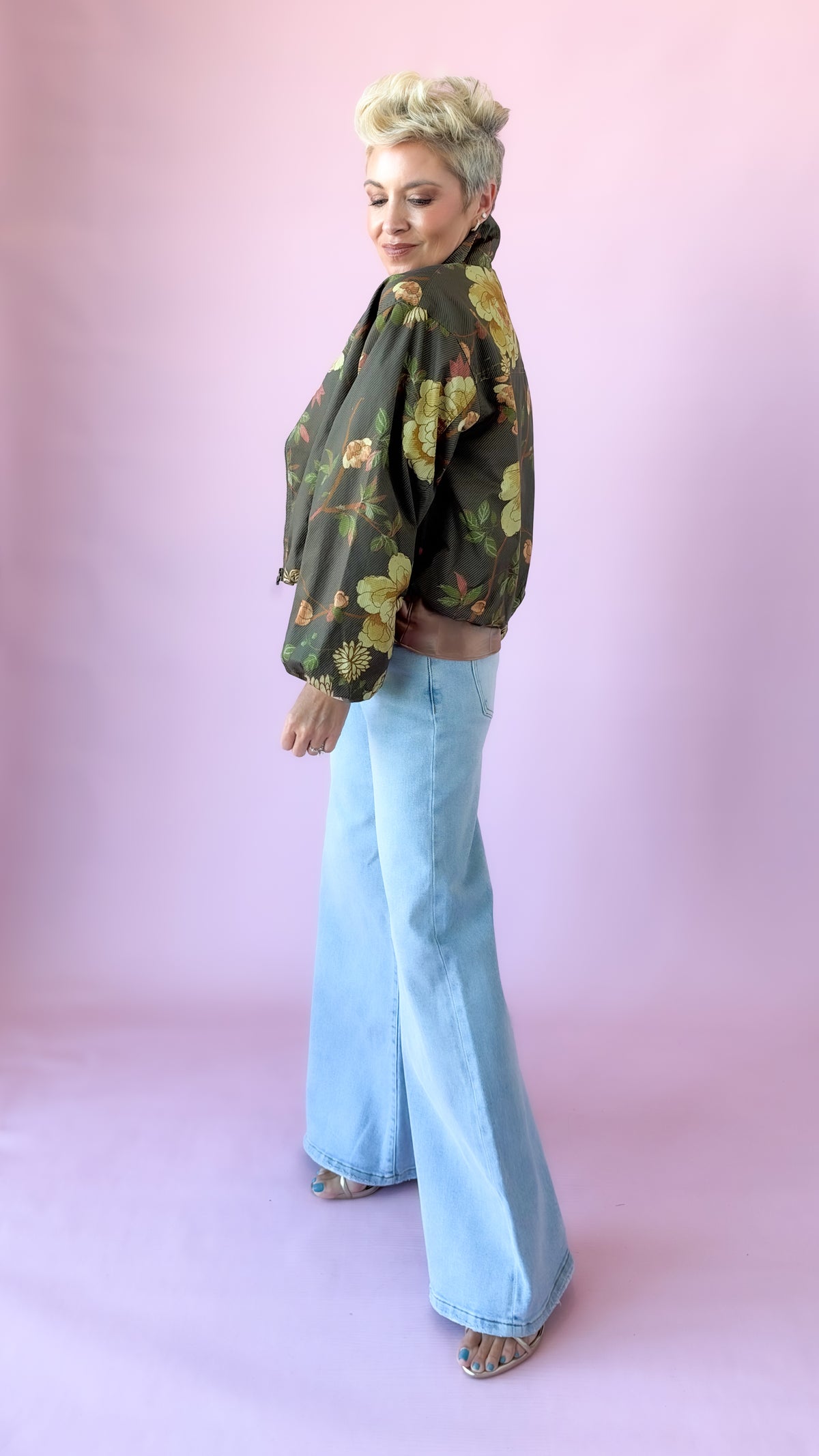 Side view of olive floral crop jacket with wide-leg jeans