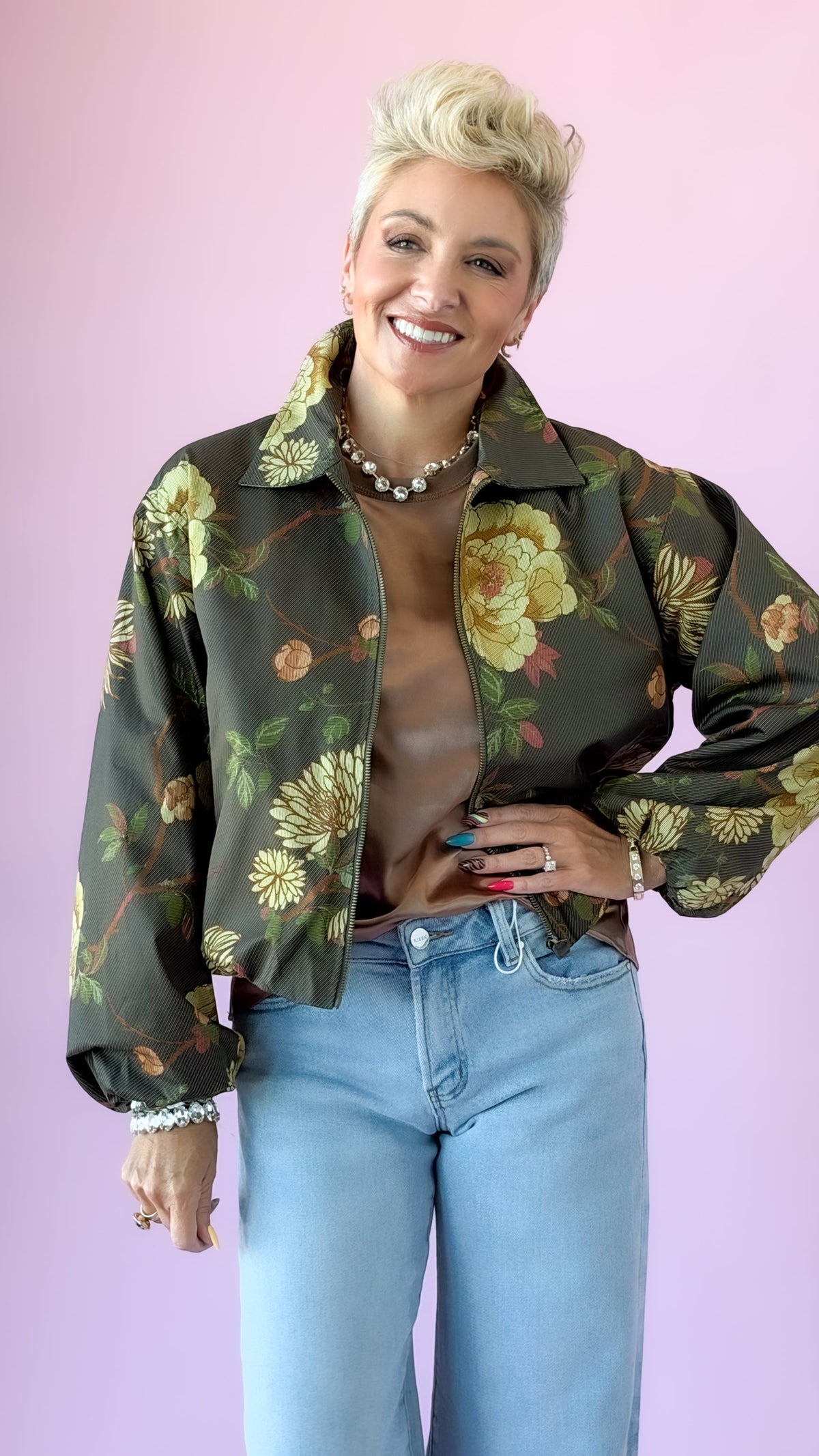 Olive floral print cropped jacket with yellow blooms, styled with light wash jeans
