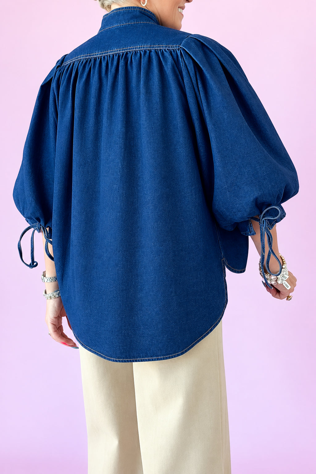 Back view of dark denim Ingrid puff sleeve top with tie cuffs
