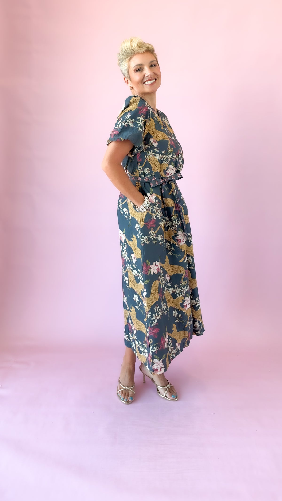 Side view of navy belted leopard print midi dress