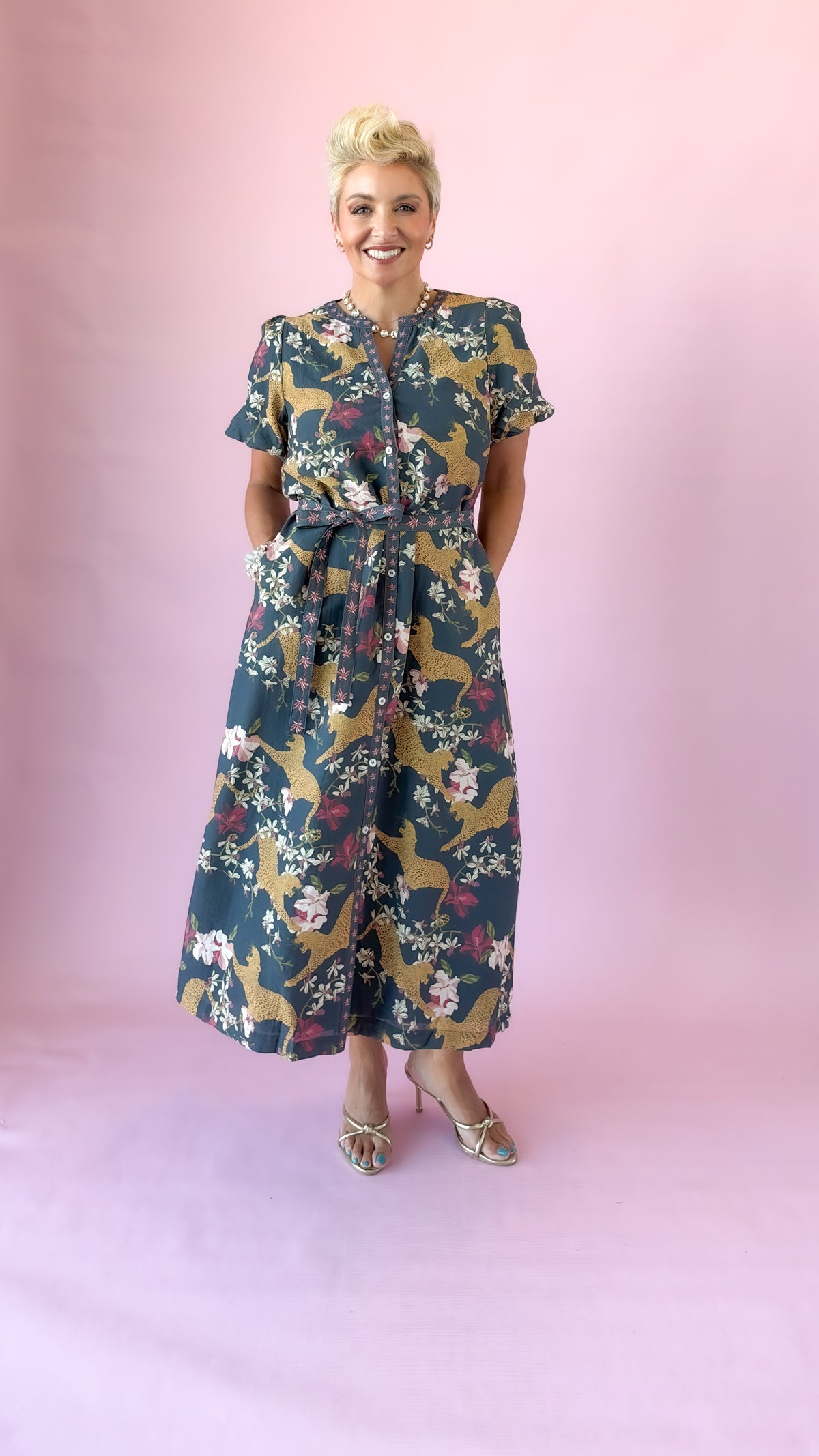 Full-length view of navy belted leopard midi dress with heels