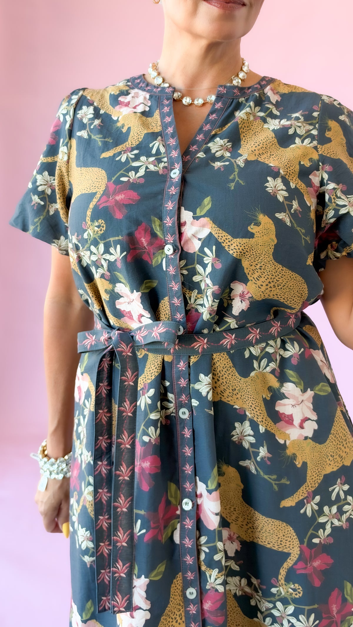 Detail of the leopard print and tie waist on the navy midi dress