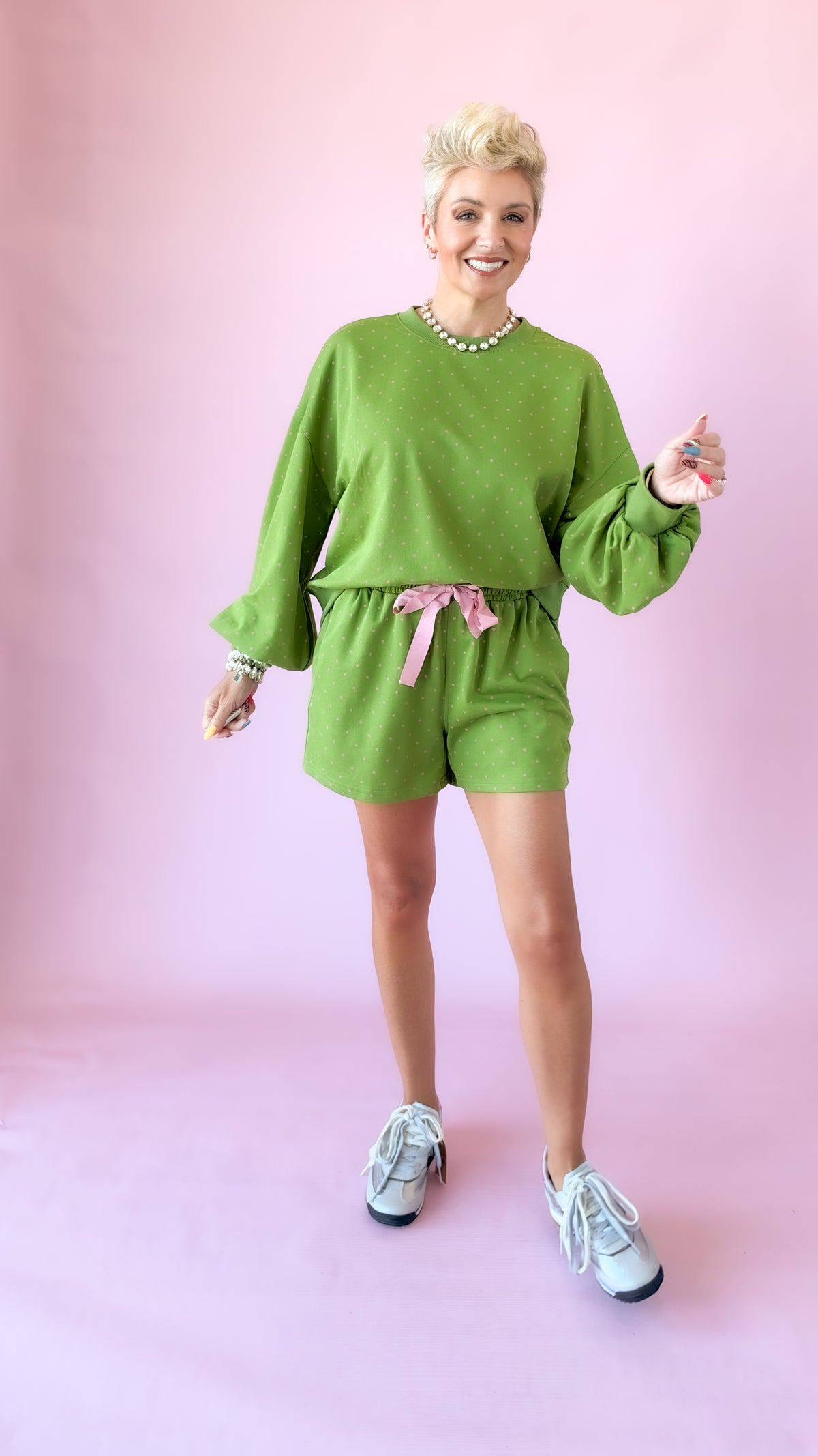 Full-length view of green lounge shorts set with white sneakers