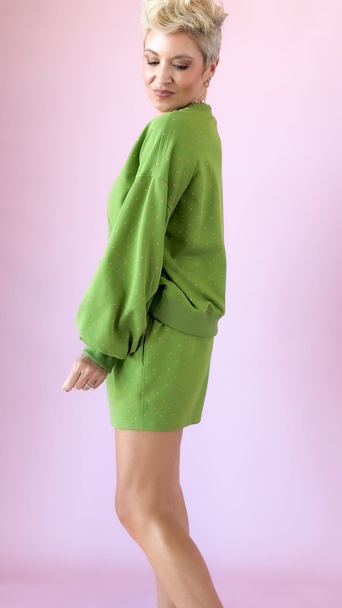 Side view of green lounge shorts and matching long sleeve top