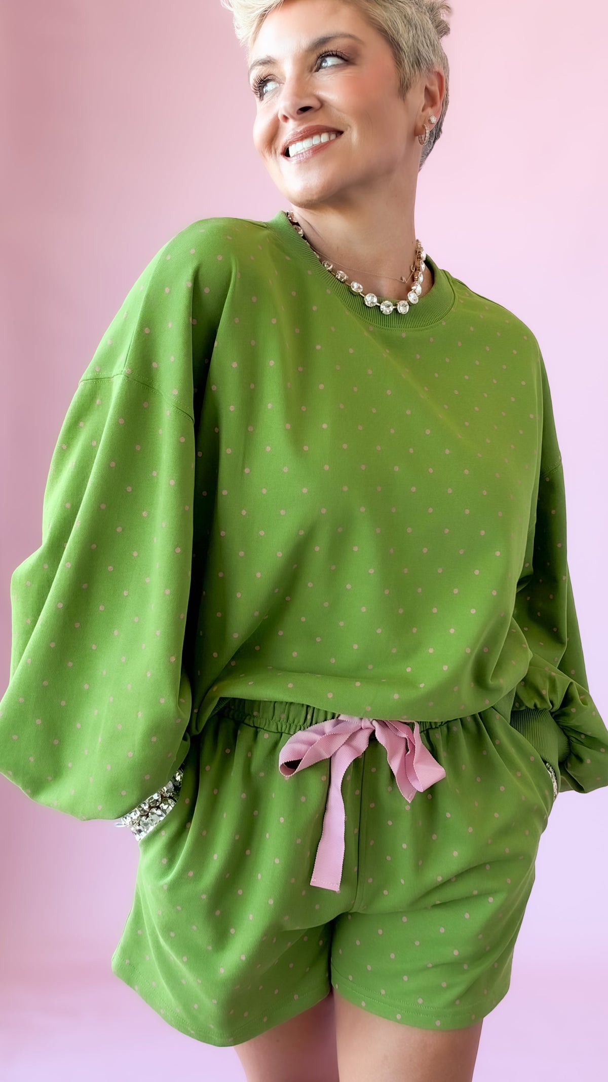 Close-up of green lounge pullover top with balloon sleeves and matching shorts