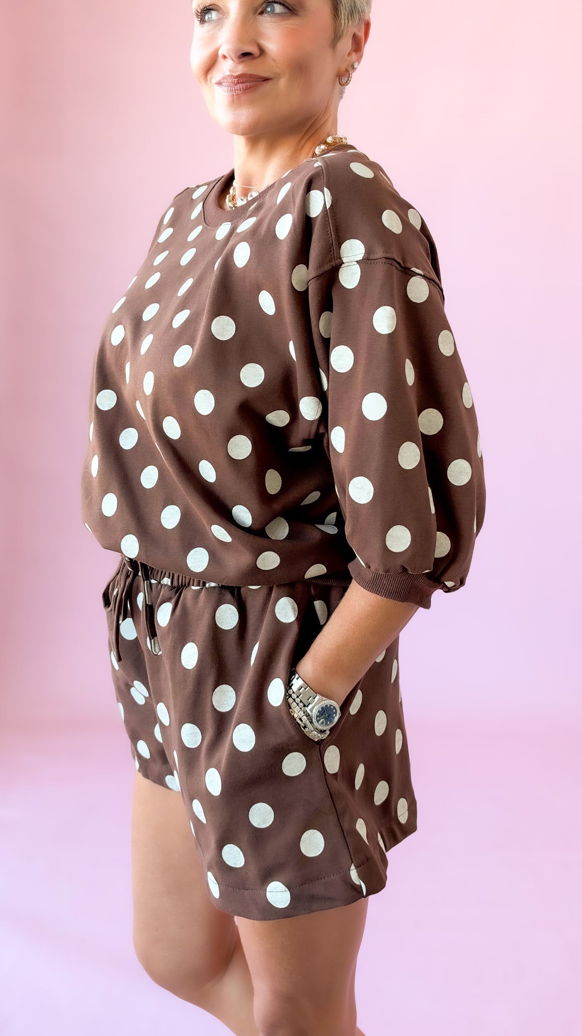 Side view of brown polka dot lounge top and shorts