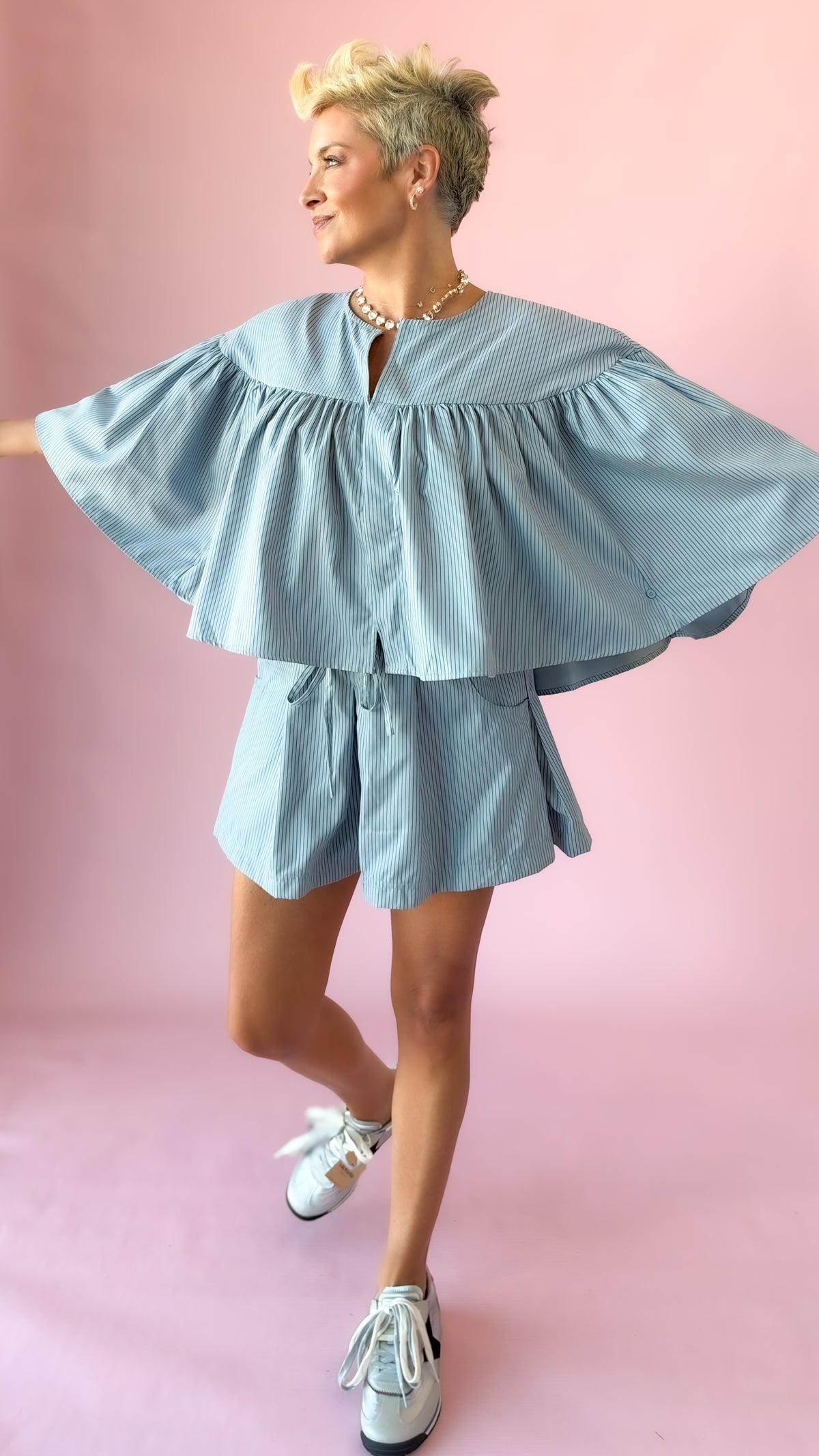 Light blue striped shorts set shown with arms out