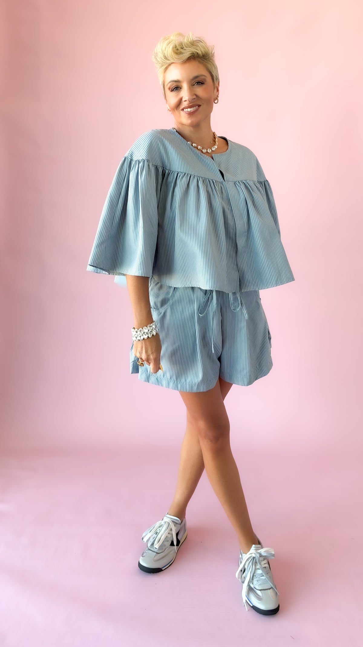 Full-length view of light blue striped shorts with matching top