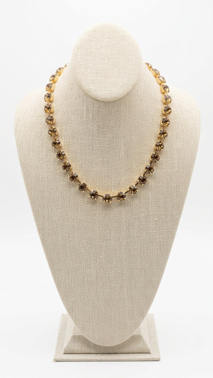 amber colored rhinestone necklace with gold metal. 18 inches long