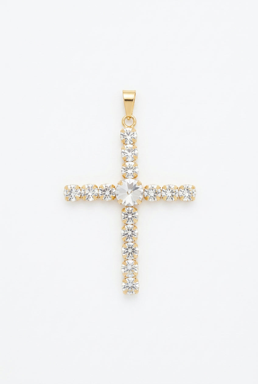 Cross pendant with rows of round clear rhinestones and a larger center stone in a gold-tone setting, shown against a white background.⠋