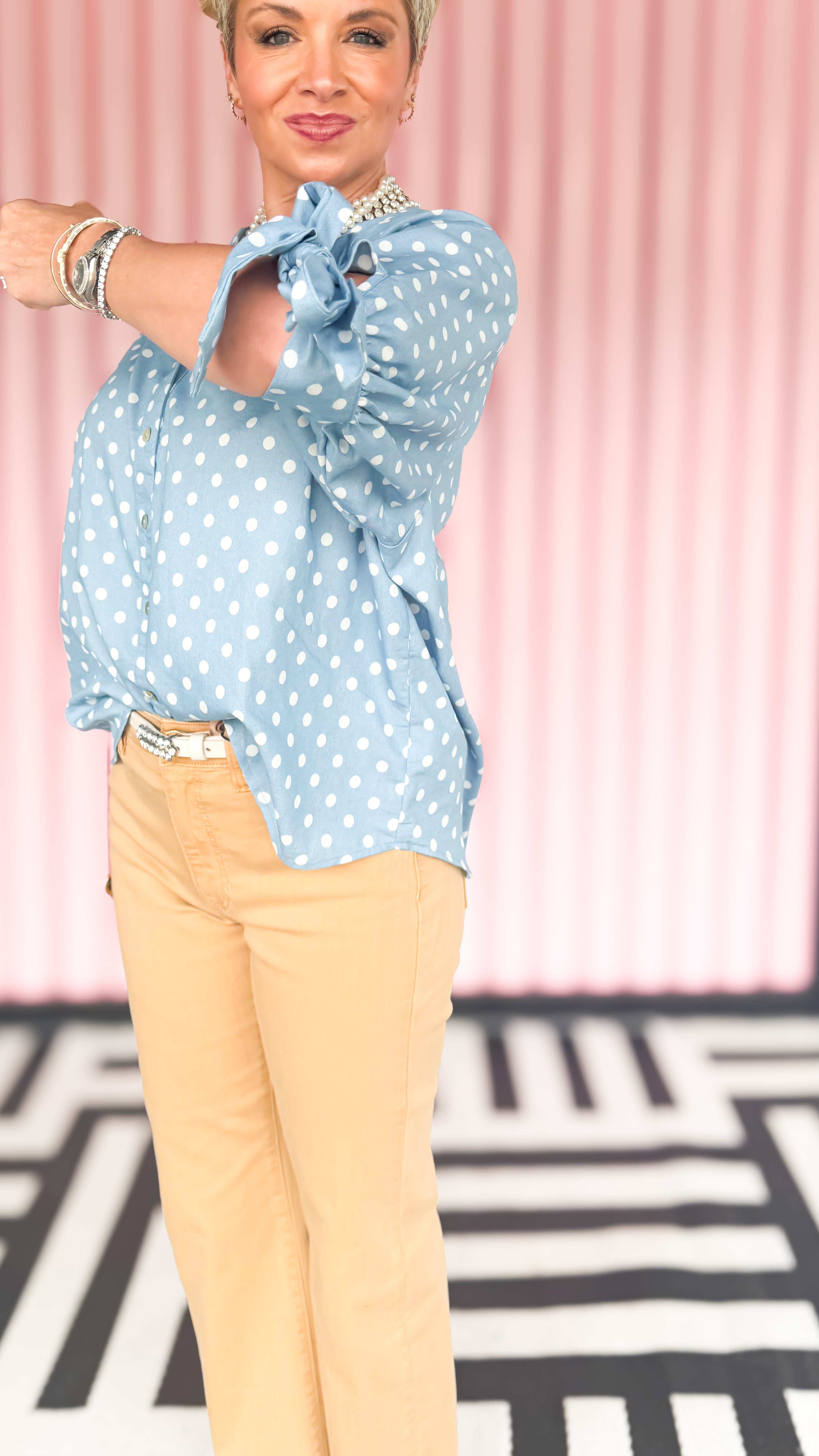 Polka dot bow sleeve blouse worn on model - side view - BLVD Boutik