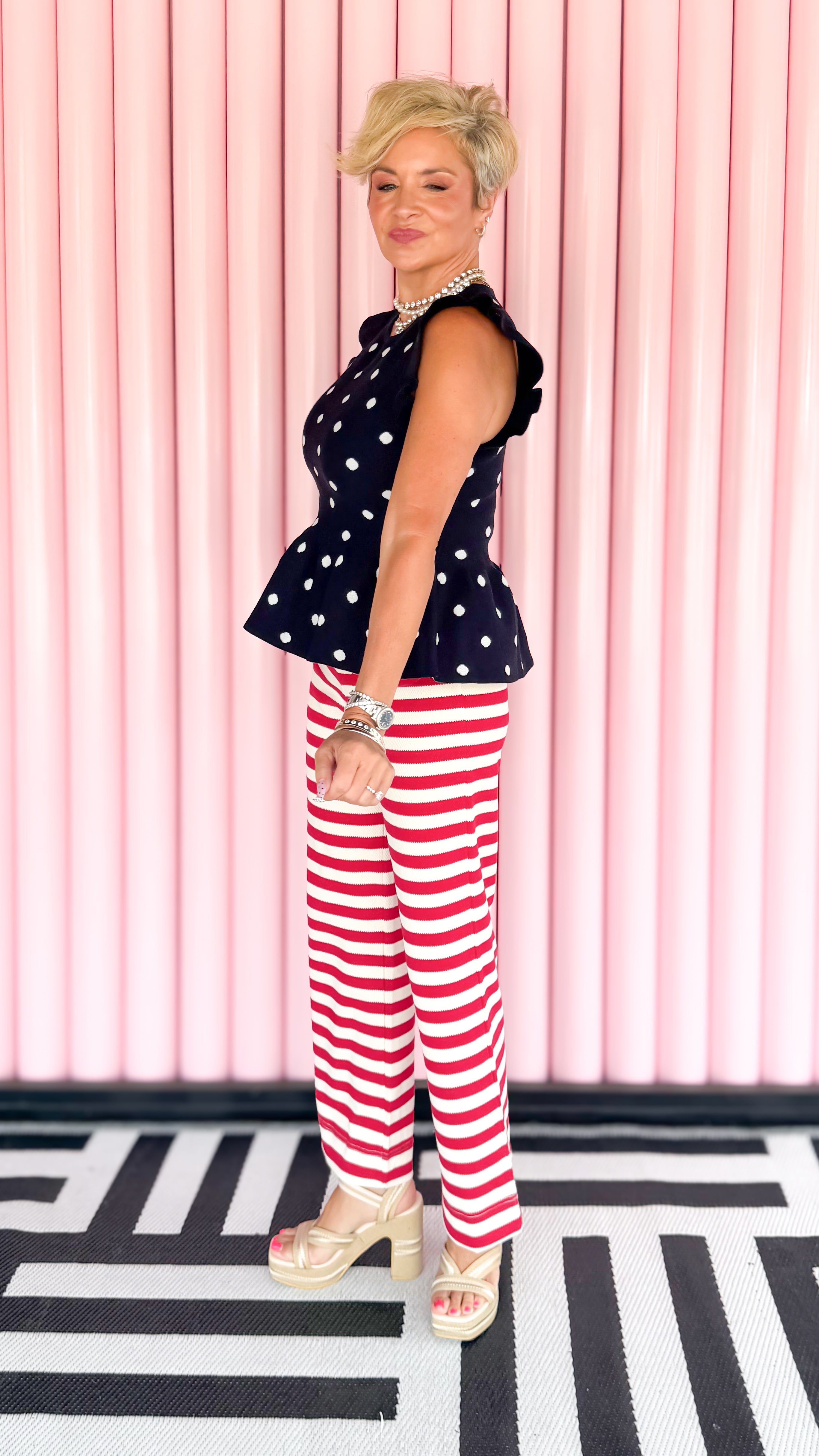 Stretchy striped wide leg pants in red worn on model - side view - BLVD Boutik