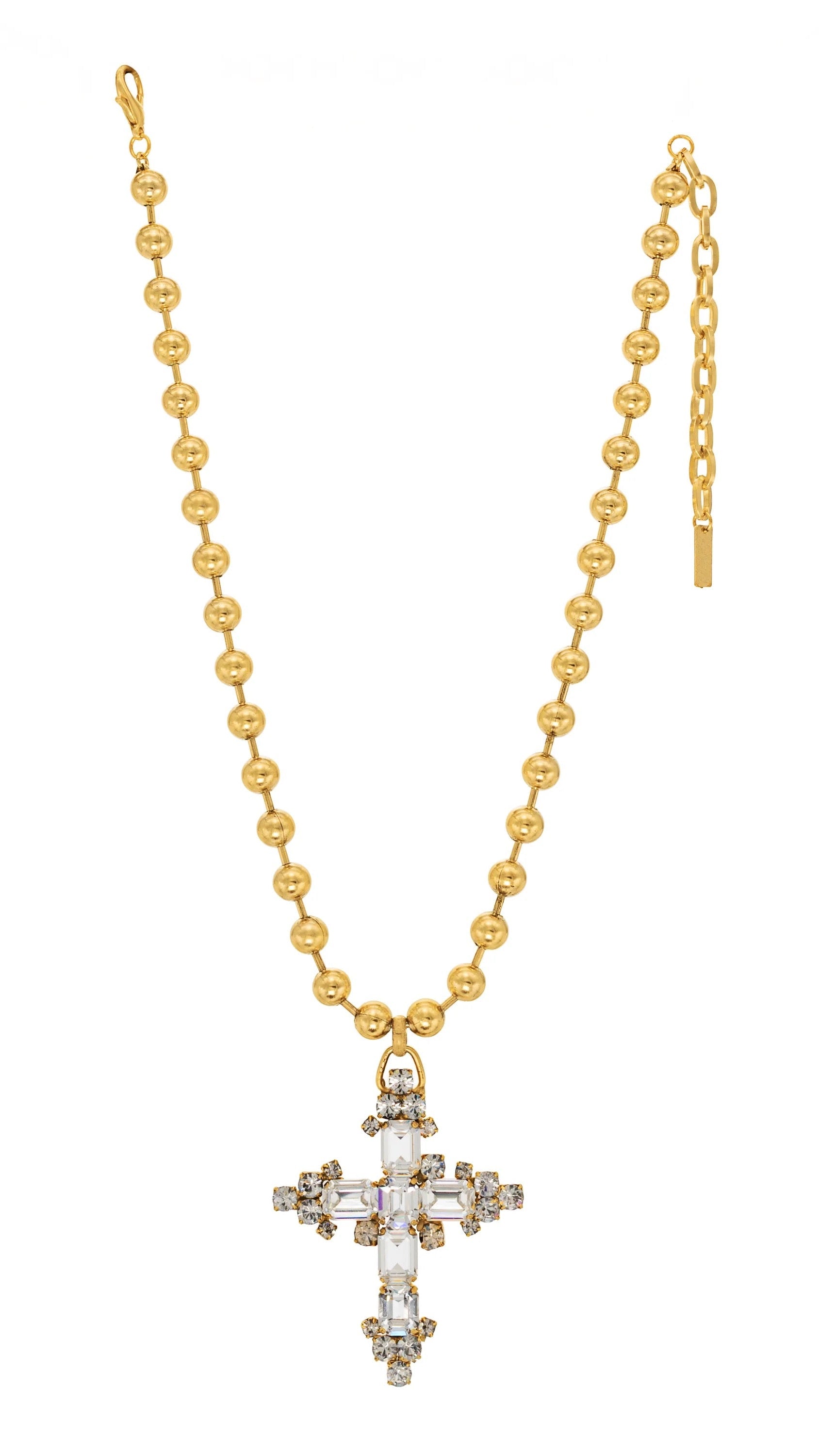 Gold necklace with a cross pendant on a white background