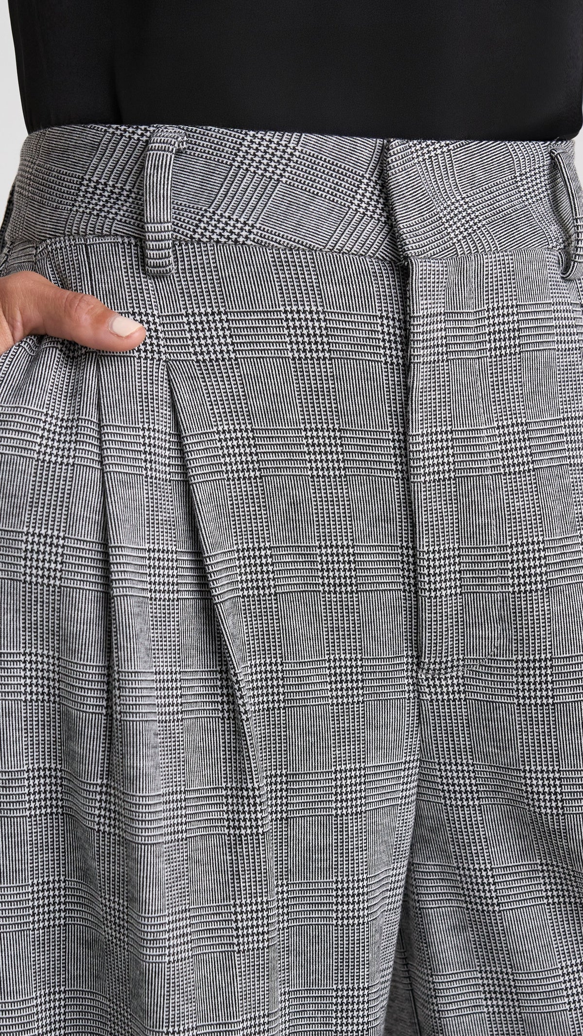 Close-up of pleats and waistband on glen plaid Brooke trousers