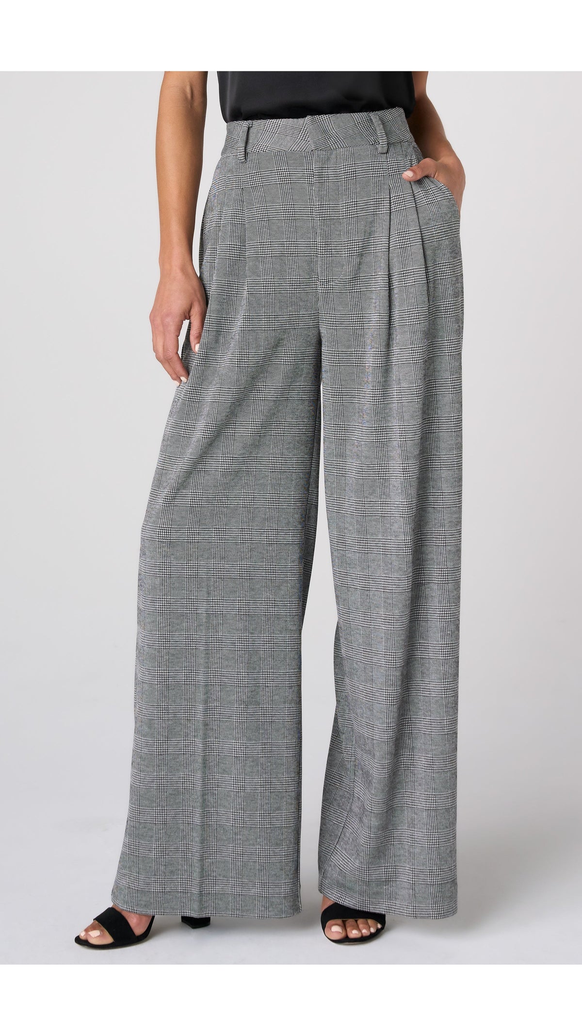 Front view of black and white glen plaid wide leg trousers with front pleats