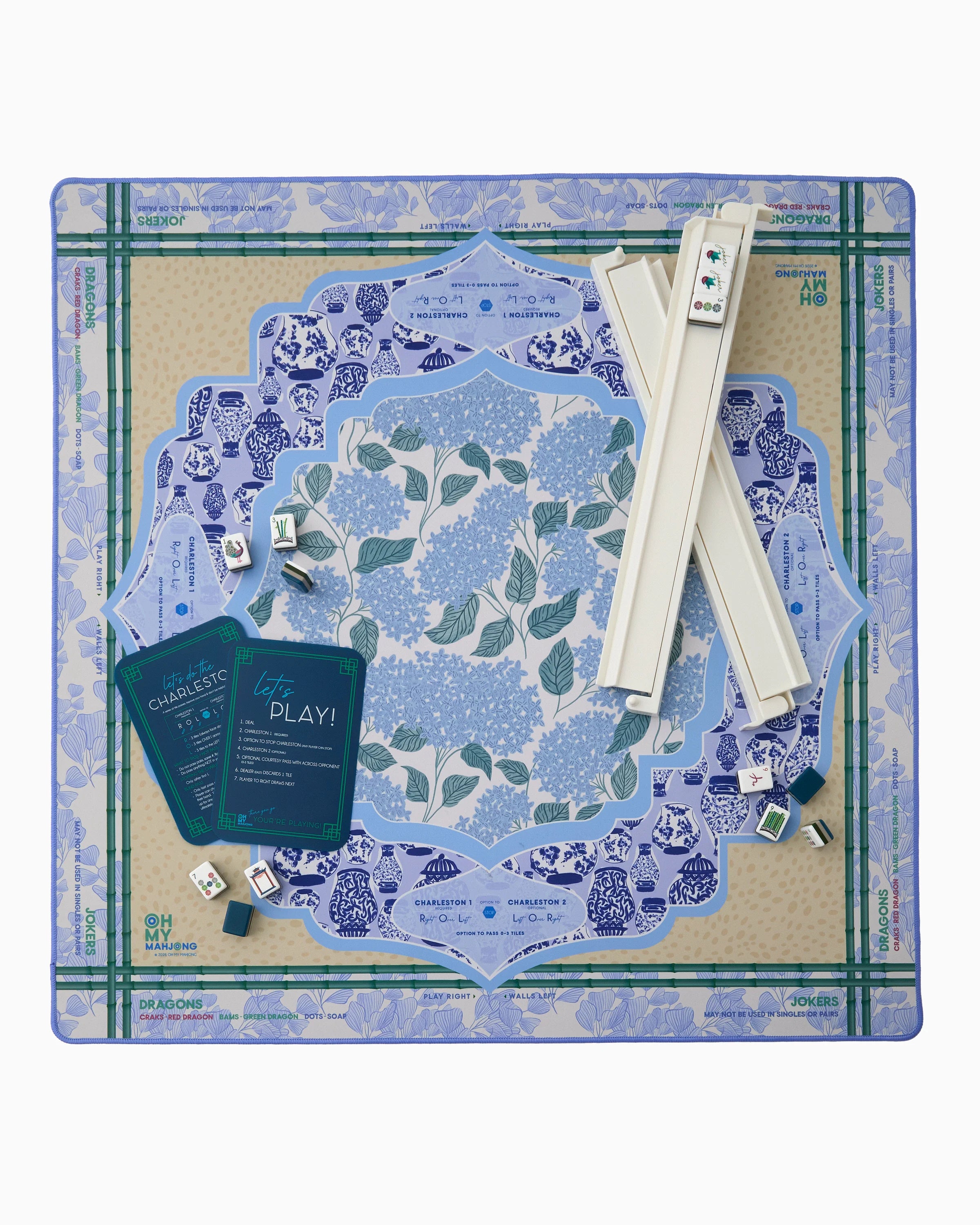 Board game set with blue and green floral design on a white background