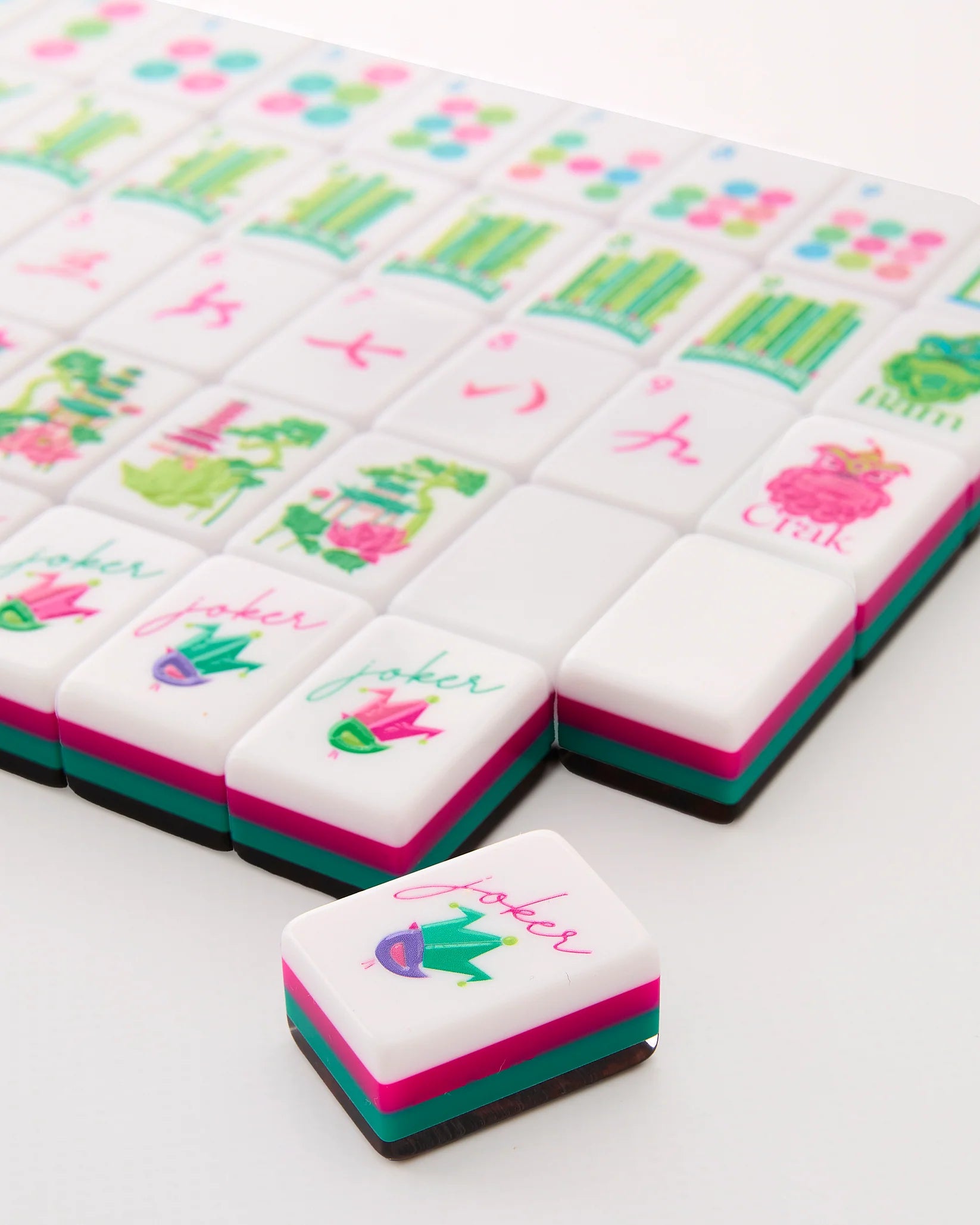 Decorative cookies with colorful designs and text on a white surface