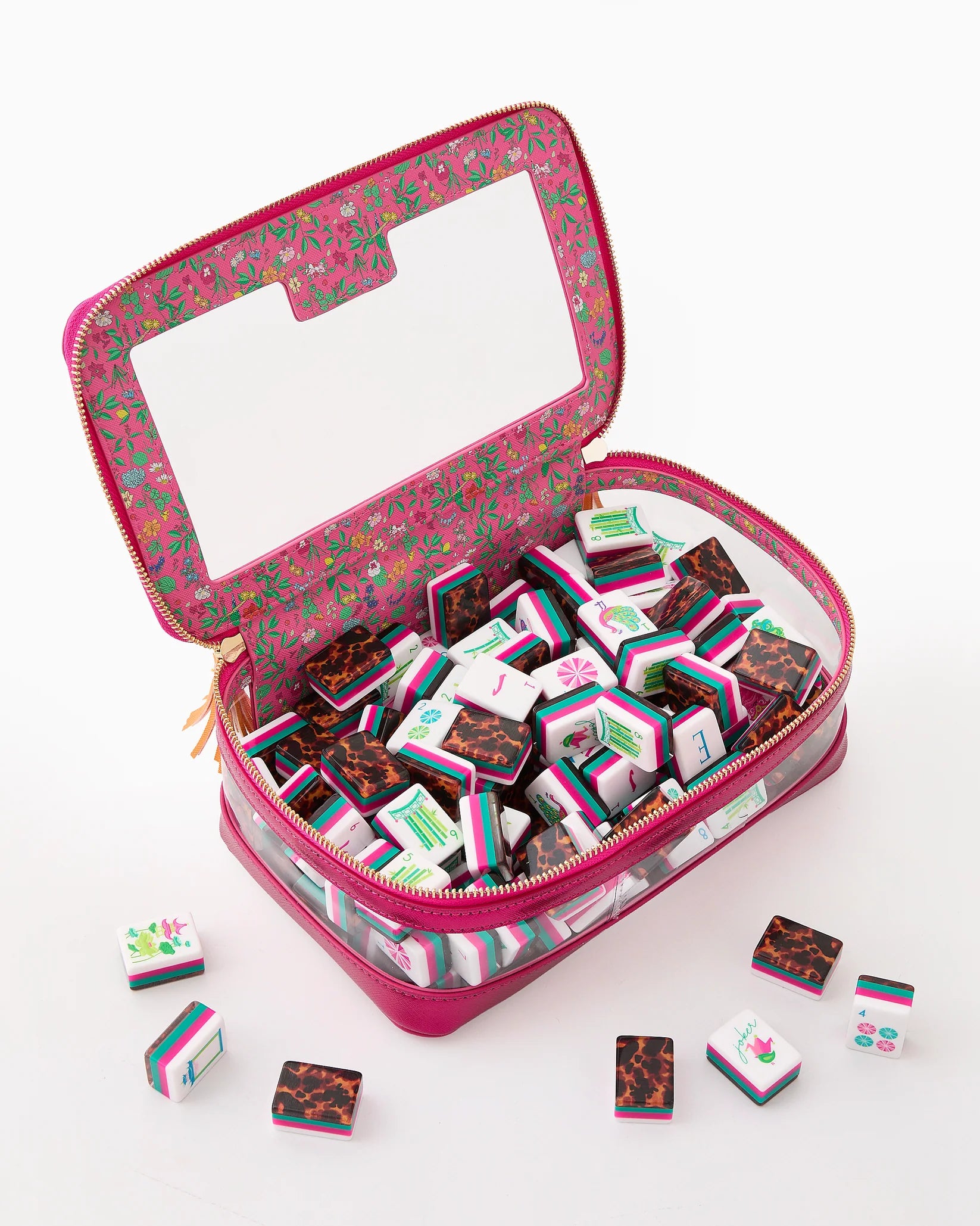 Pink floral-patterned jewelry case with small boxes of chocolates on a white background