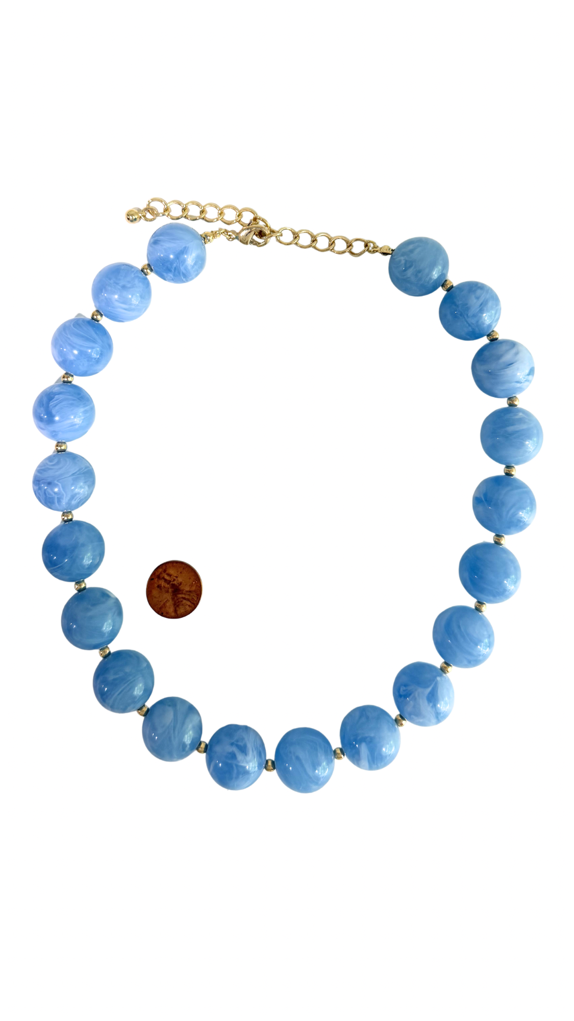 Necklace with blue beads and a gold chain on a white background