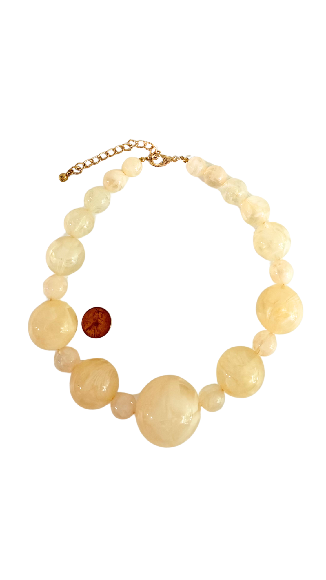 Necklace with large beige beads on a white background