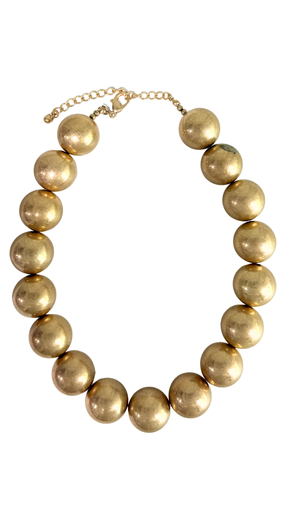 Gold beaded necklace on a white background